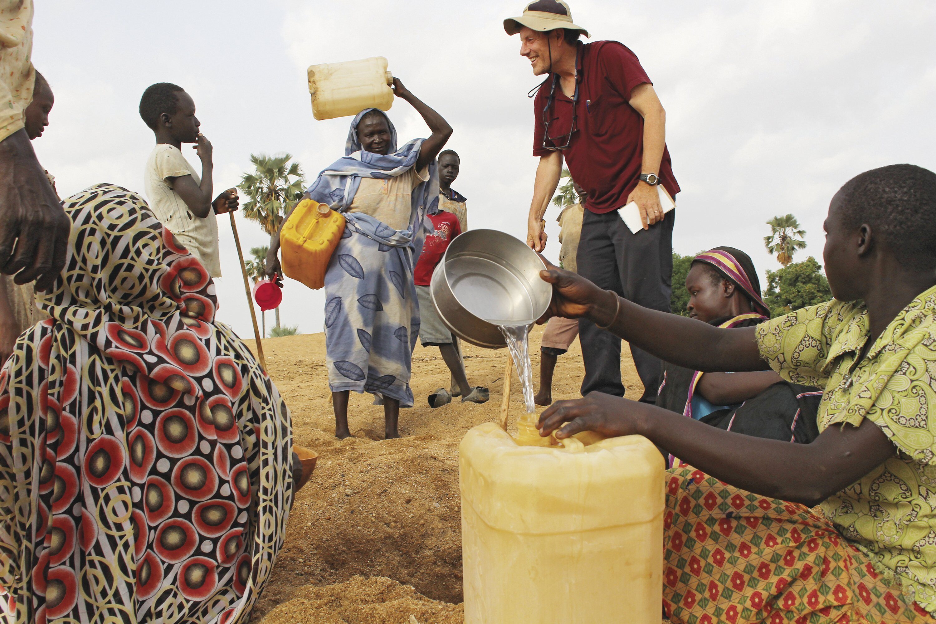 REACHING OUT: Nicholas Kristof interviews villagers in the rebel-held Nuba Mountains of Sudan last year. 