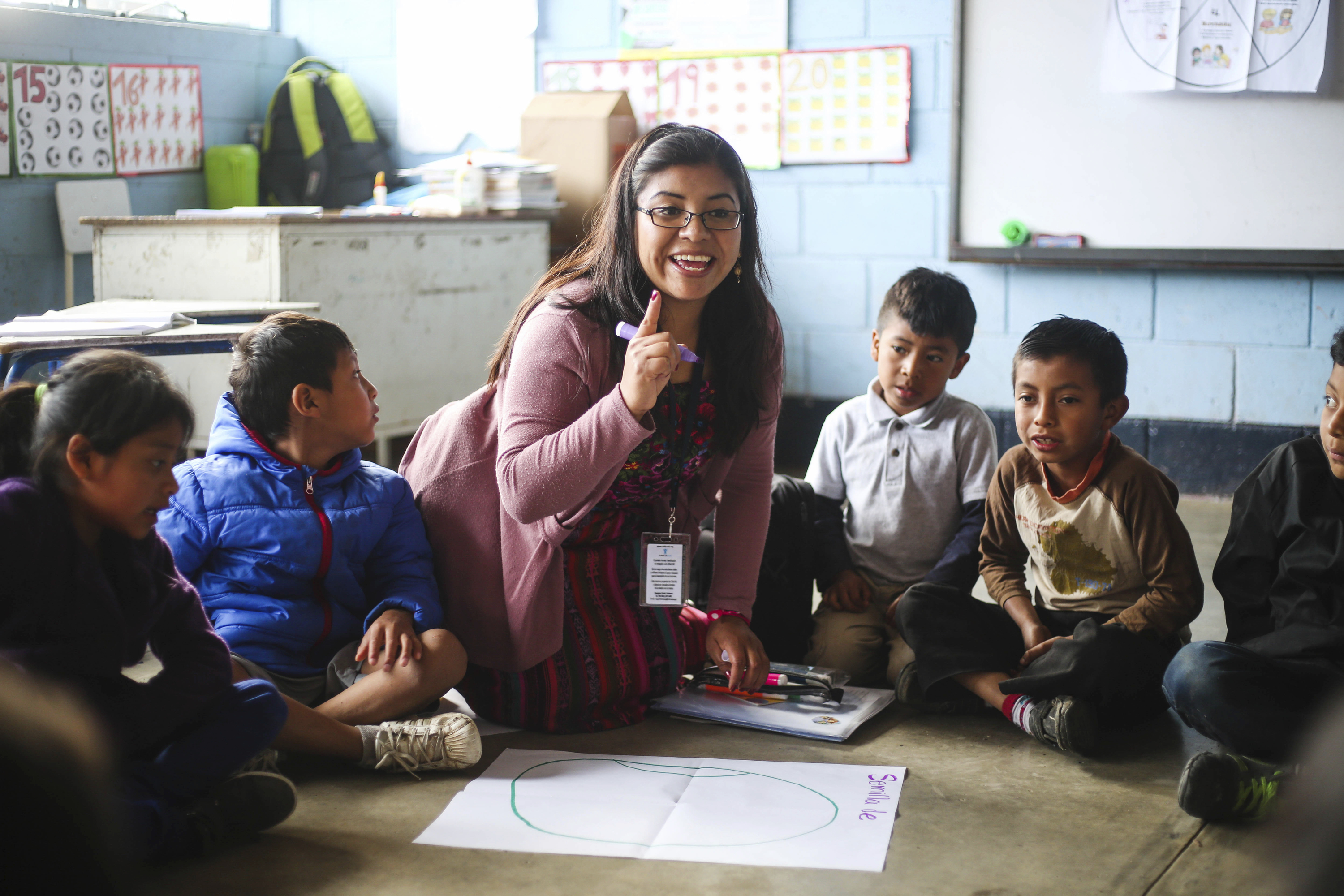 A child literacy trainer, Marilena Ixen, works with children at a school in Godinez, Guatemala. 