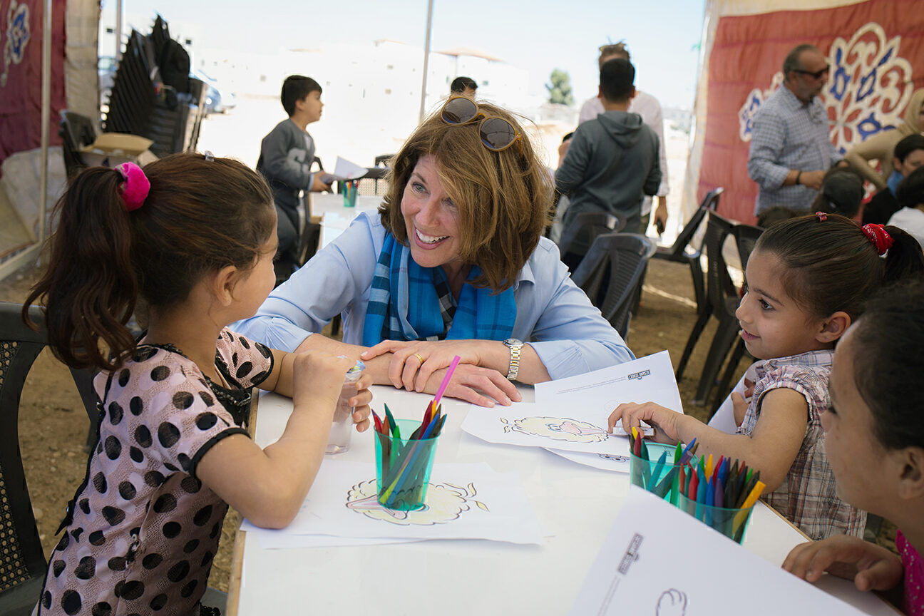 Sherrie Westin meets children in a refugee settlement in Mafraq, Jordan, in May 2017. 
