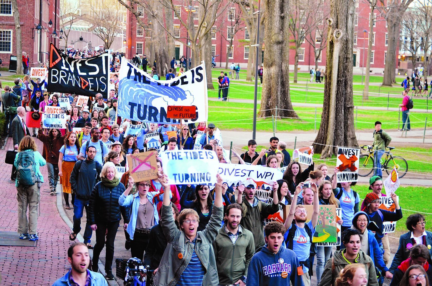 ACT NOW - Students, faculty members, and others from Boston-area colleges march at Harvard to demand that universities sell their oil, gas, and coal investments. 