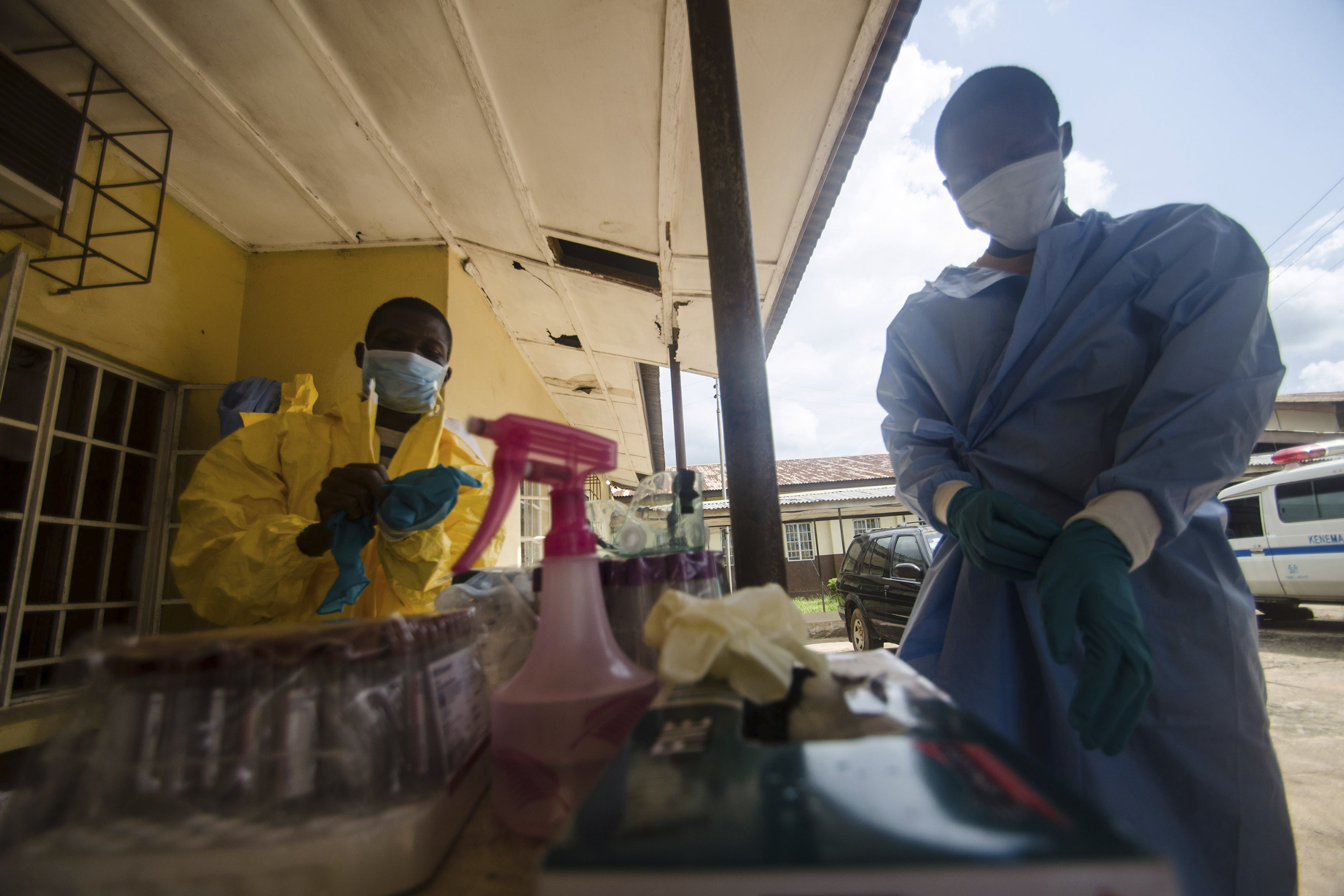 Medical staff put on protective gear in Kenema Government Hospital before taking a sample from a suspected Ebola patient.  