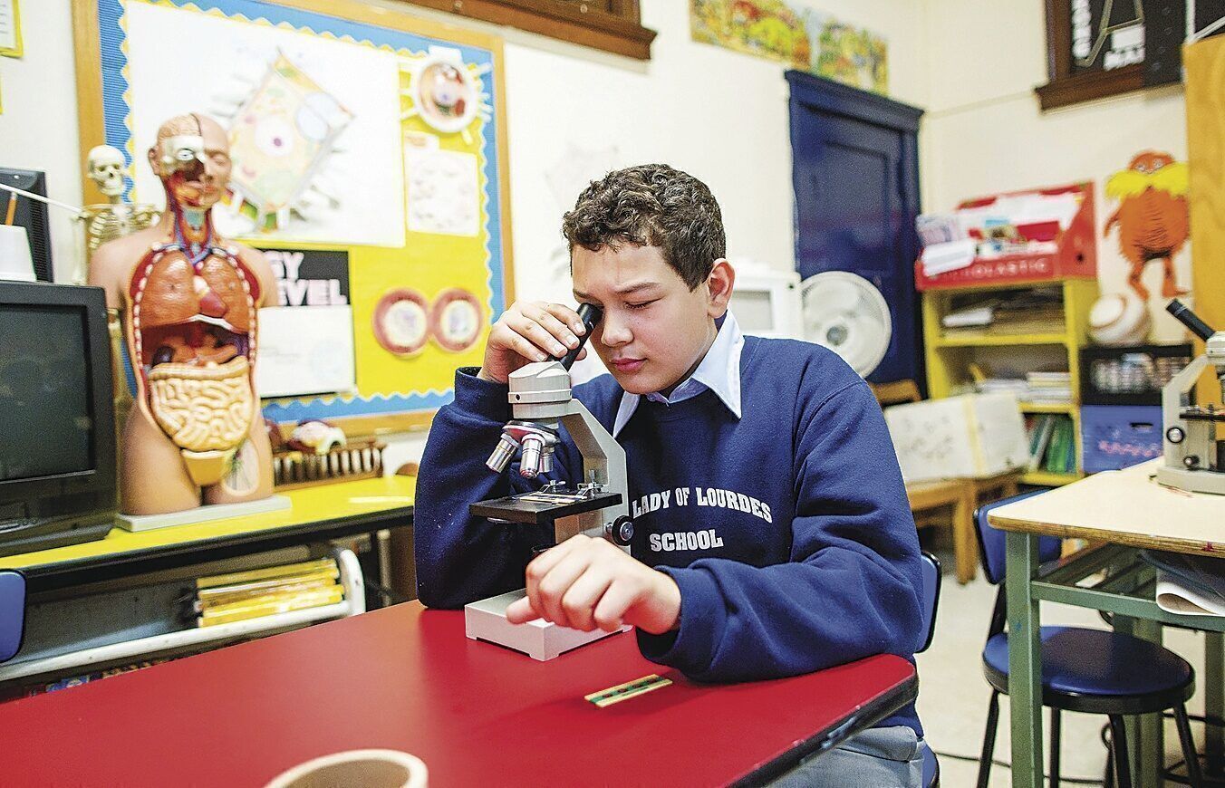 Students supported by donors through the Inner-City Scholarship Fund are passionate about discovering new things, even through a microscope in science class. All Inner-City students receive a values-based, quality Catholic education within the Archdiocese of New York. (Inner-City Scholarship Fund)