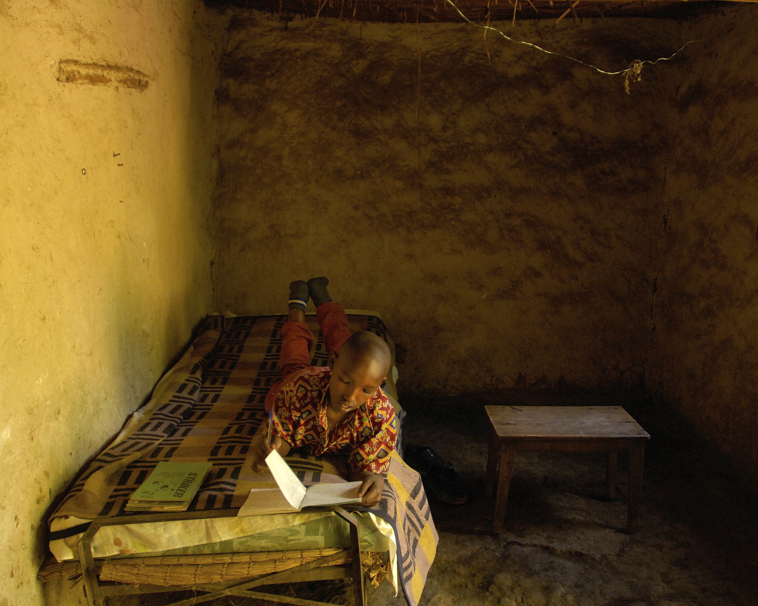 Joseph Ahimbisibwe, 15, aspires to be a teacher. He and his sister are being raised by their grandparents in Uganda; their parents left to find land to farm.