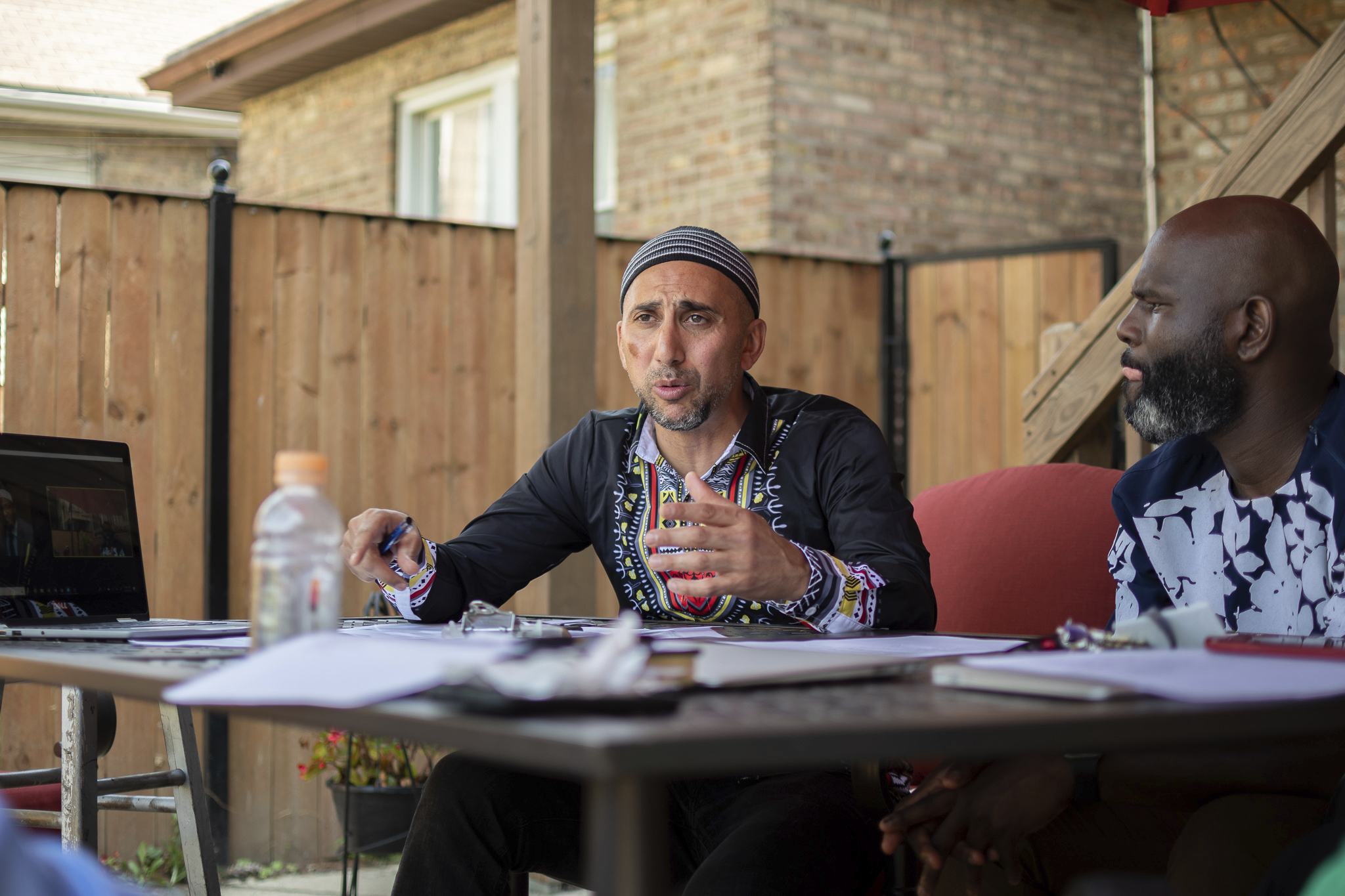 Rami Nashashibi in a meeting with IMAN committee members in the group’s backyard garden.