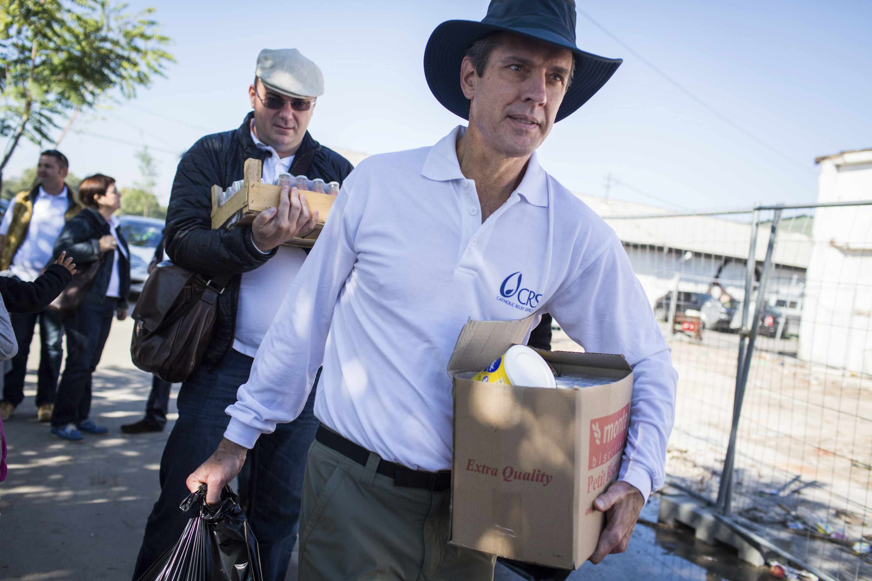 FOCUSED COMMITMENT: Catholic Relief Services chief executive Sean Callahan has traveled the world for the organization since he started working there as a fellow in 1988. Here he is shown with program manager Dino Mujanovic, in Belgrade, Serbia, with supplies for refugees who are crossing into Croatia. 