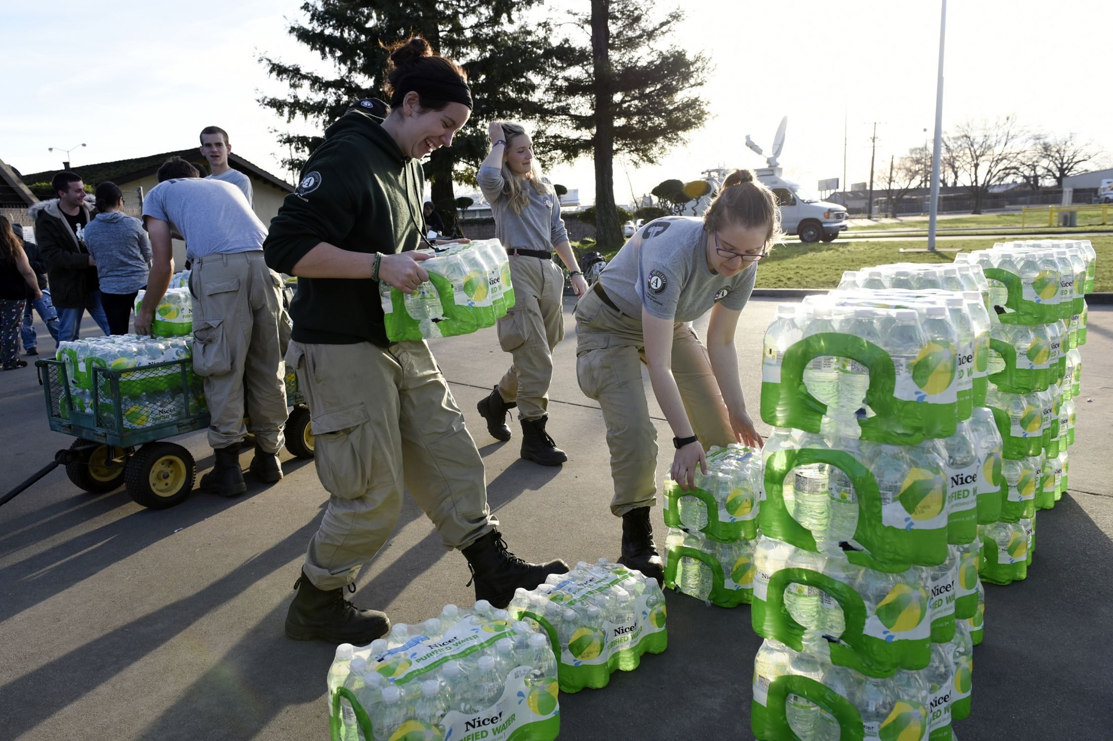AmeriCorps volunteers help deliver supplies in Northern California amid flood warnings last month. President Trump’s budget plan calls for eliminating the Corporation for National and Community Service, the federal agency that oversees AmeriCorps.