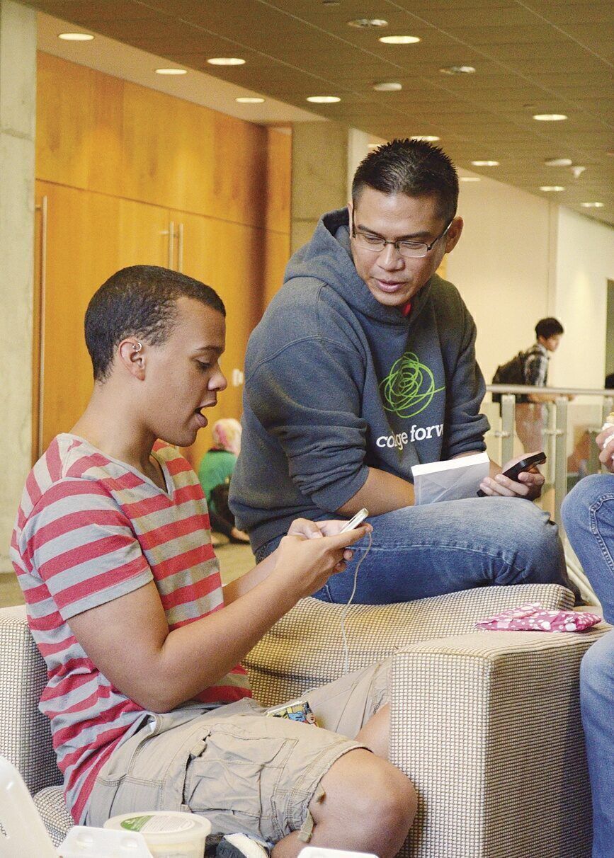 A coach with College Forward helps a freshman at the University of Texas at Austin troubleshoot a financial-aid issue. 