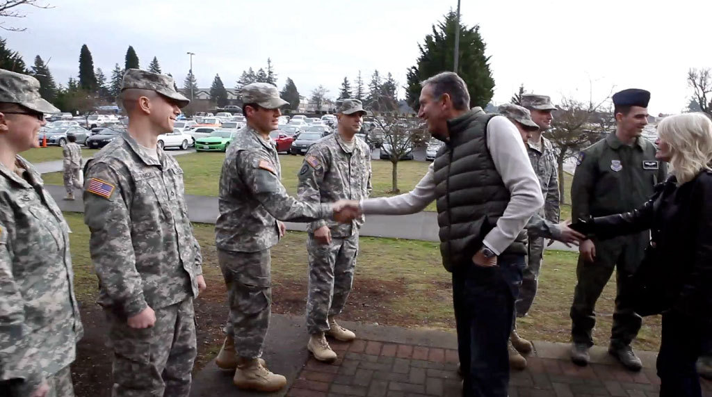 Howard Schultz, CEO of Starbucks, and his wife Sheri meet with service members at Joint Base Lewis-McChord in Washington. 