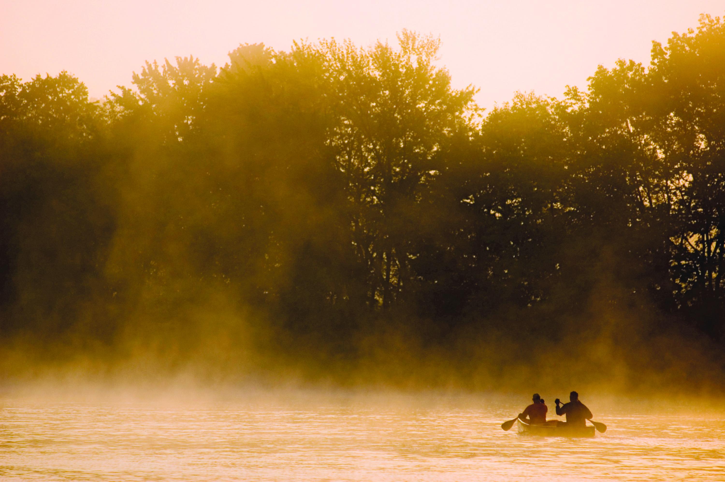 A canoe in the early morning mist on the Penobscot River in Maine. 