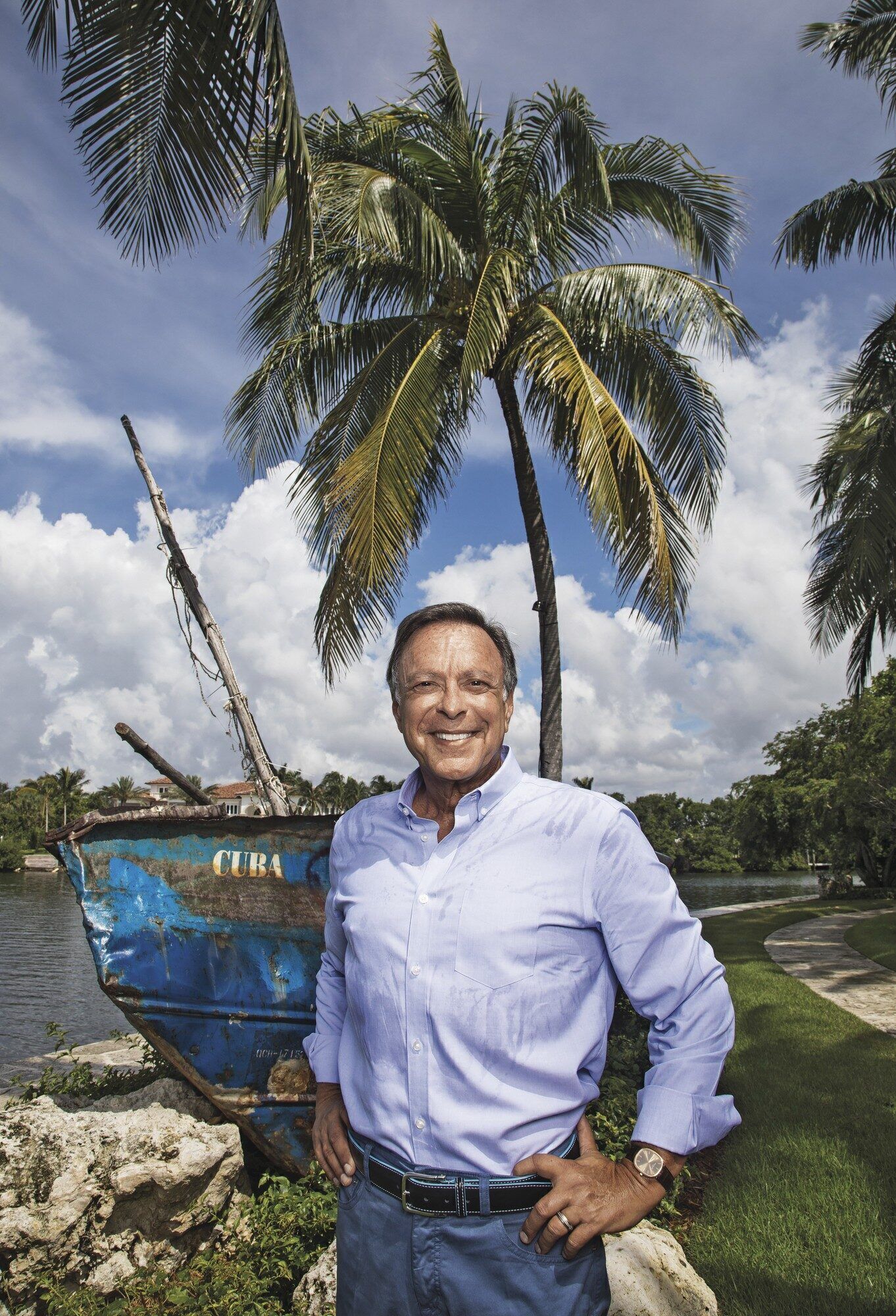 Cuban-American philanthropist Miguel Fernandez at his Florida home, where he displays a boat that once carried Cuban refugees.