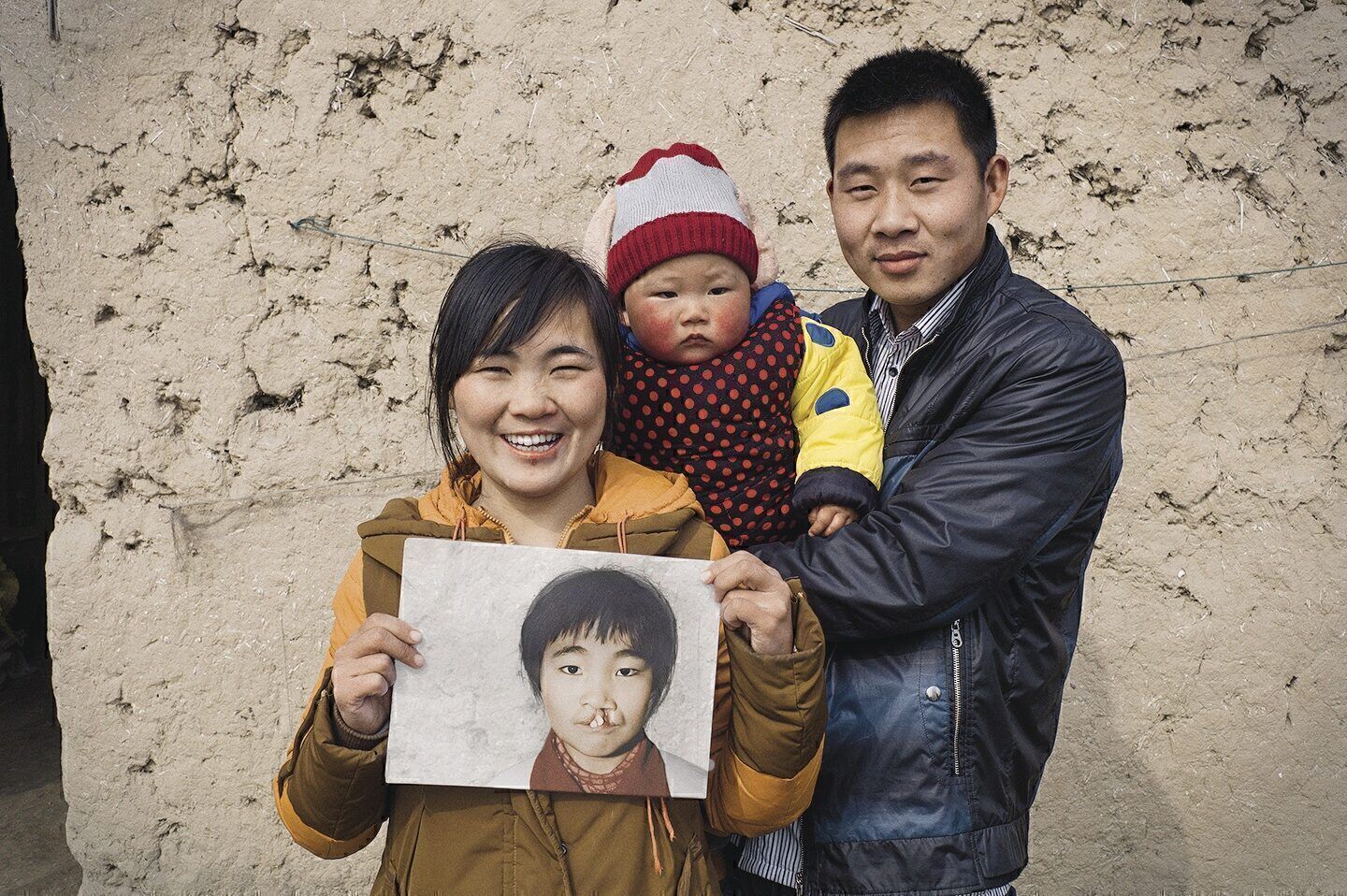 REASON TO SMILE: Smile Train landed on the Philanthropy 400 just 10 years after its first patient, Wang Li (shown here with husband and son) had surgery to repair a cleft palate.