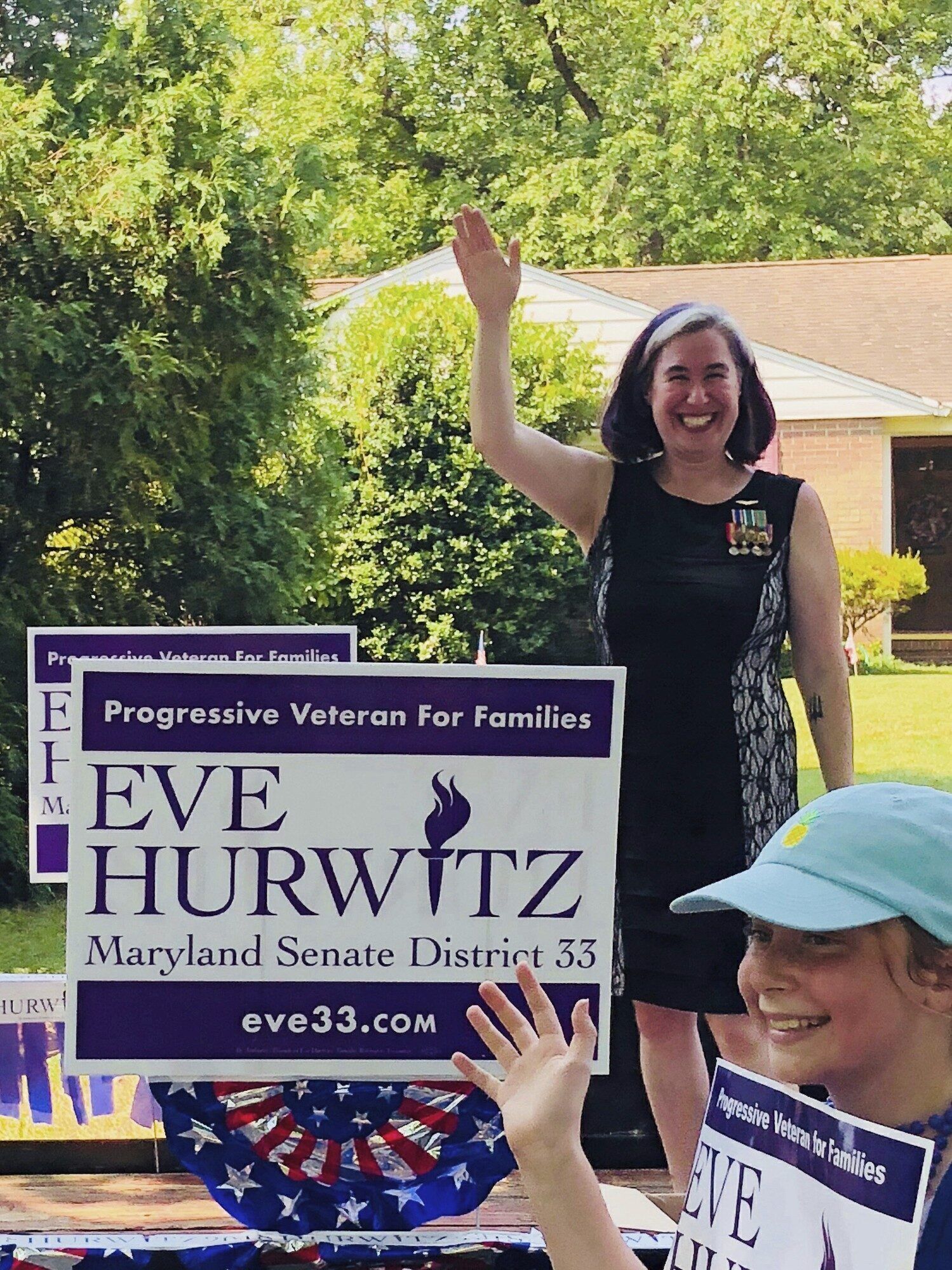 Eve Hurwitz flew planes in the Navy, has five kids, and runs a small business. She’s also running for a seat in the Maryland Senate. Her dark purple campaign signs match her hair.