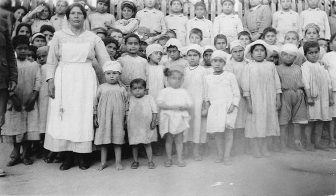 Relief worker with Armenian children.