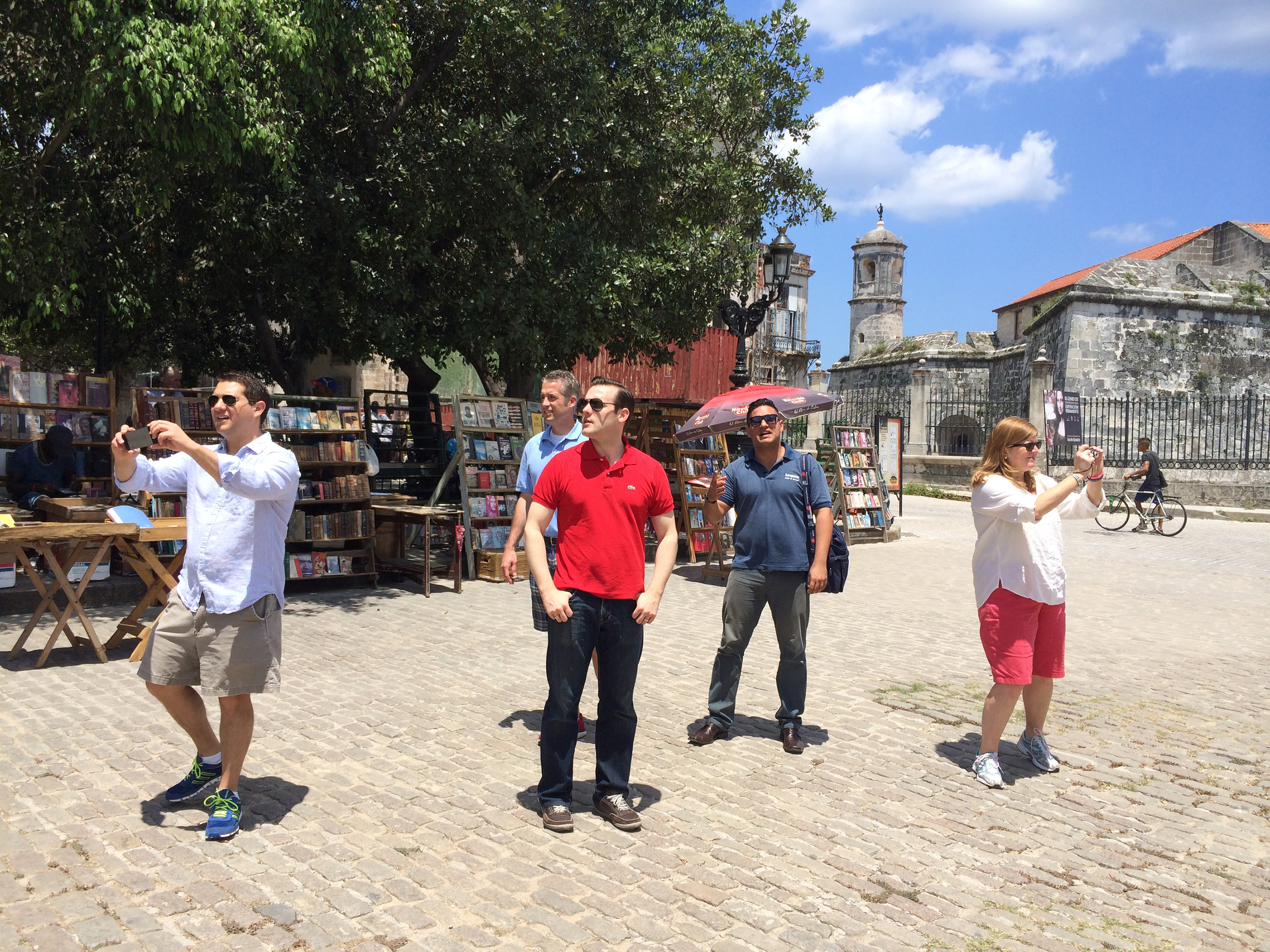 Dean Hingson, Todd Novascone, Michael Kennedy, and Helen Tolar, chiefs of staff to members of the United States Senate, walk through the Plaza de Armas in Havana, Cuba, during a May 2014 visit to the island hosted by the Center for Democracy in the Americas.