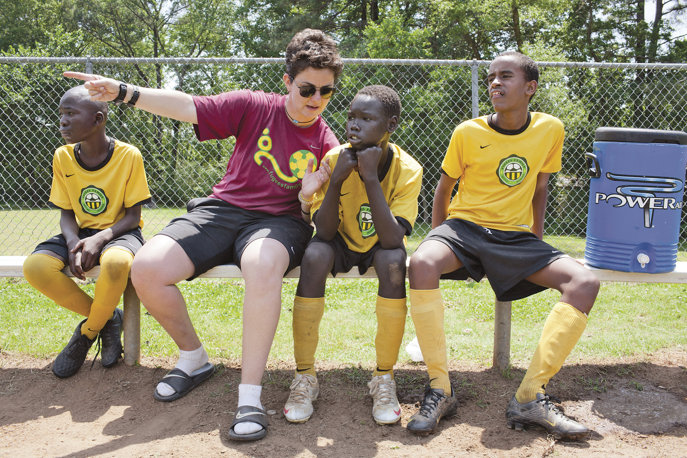 LESSONS ON THE FIELD: Luma Mufleh (second from left) started Fugees Academy, a private school for refugee children in Clarkston, Ga., where teamwork is a required part of the curriculum.