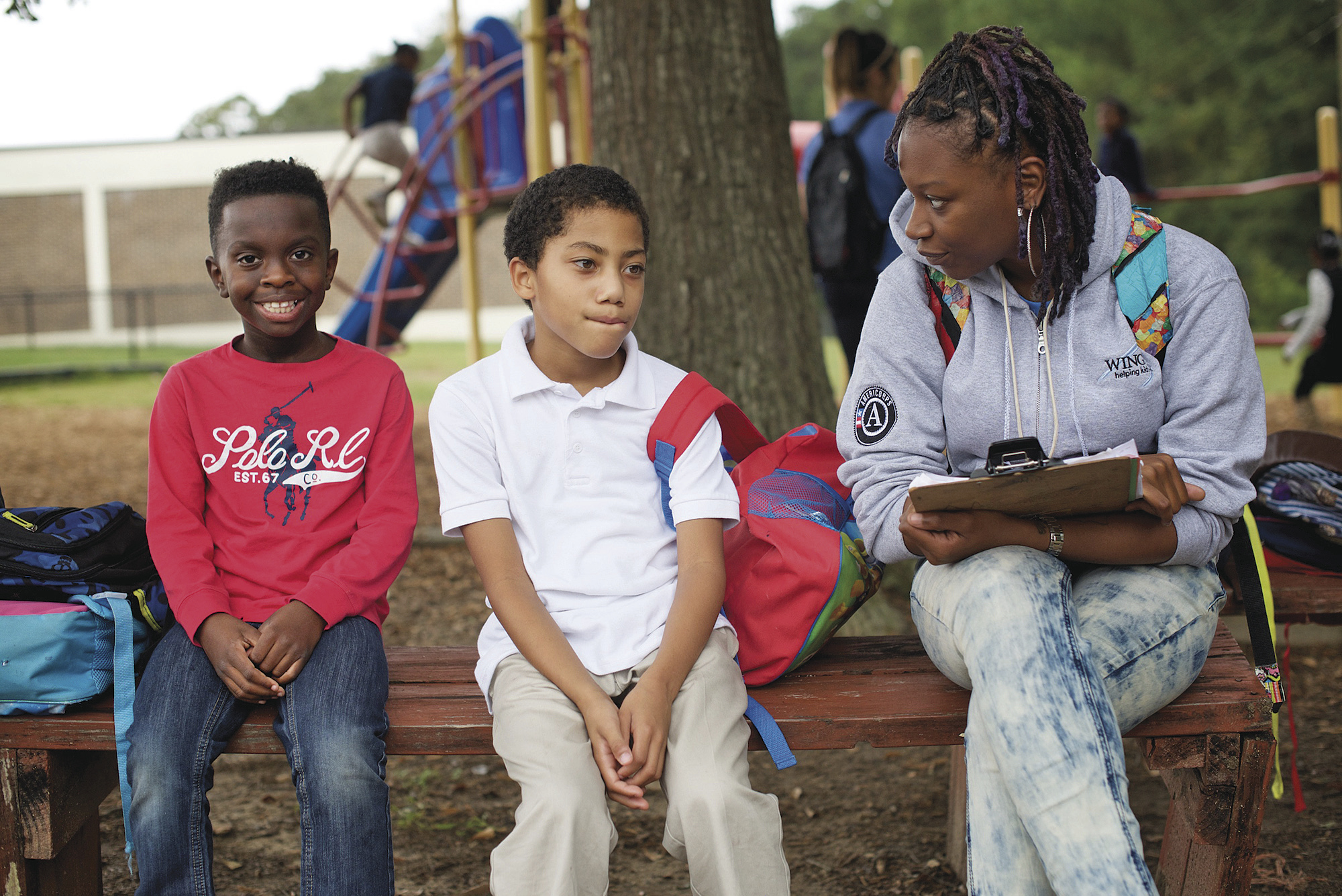 A volunteer works with children at a Wings for Kids after-school program. The southeastern youth charity has utilized the Performance Imperative management principles developed by Morino’s Leap of Reason organization.