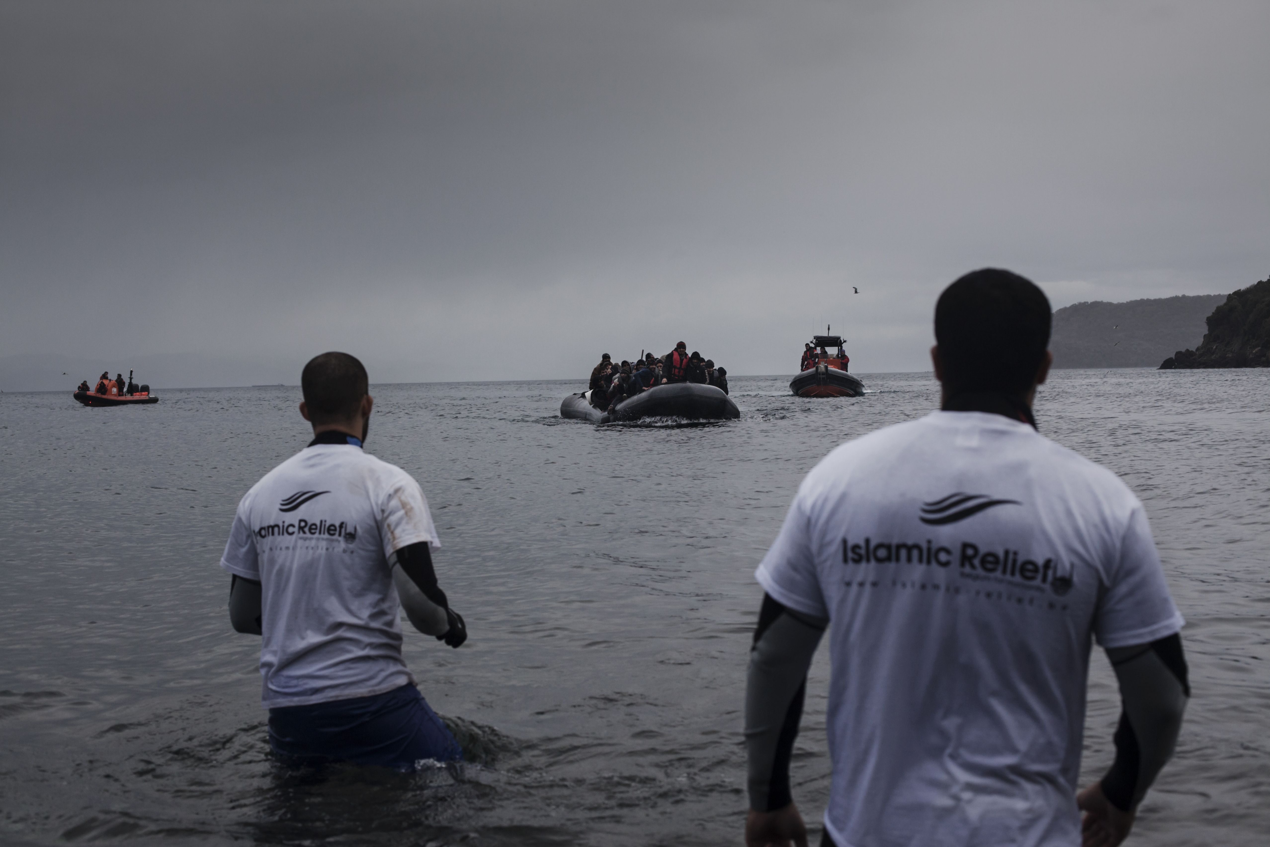 Volunteers from Belgium Islamic Relief NGO prepare to assist refugees from Afghanistan and Syria arriving in boats on the shores of Lesbos near Skala Sikaminias, Greece on Jan. 5, 2016.