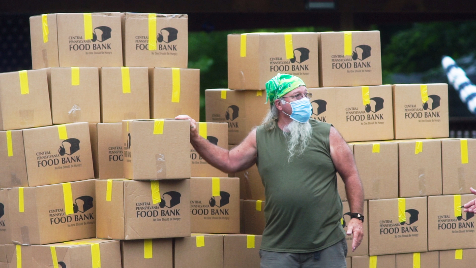 Photo of a volunteer distributing boxes of food