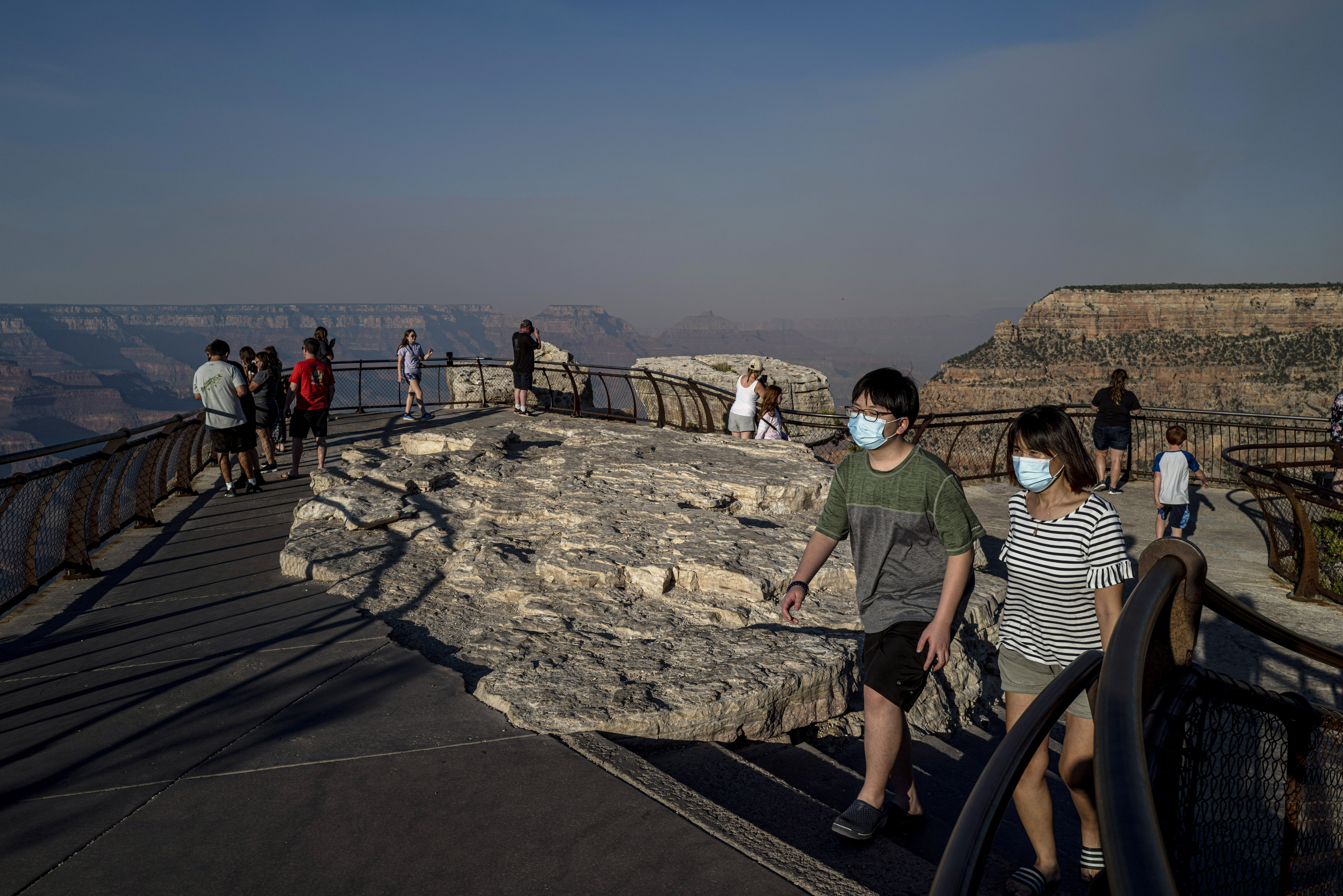 Photos of masked visitors at the Grand Canyon