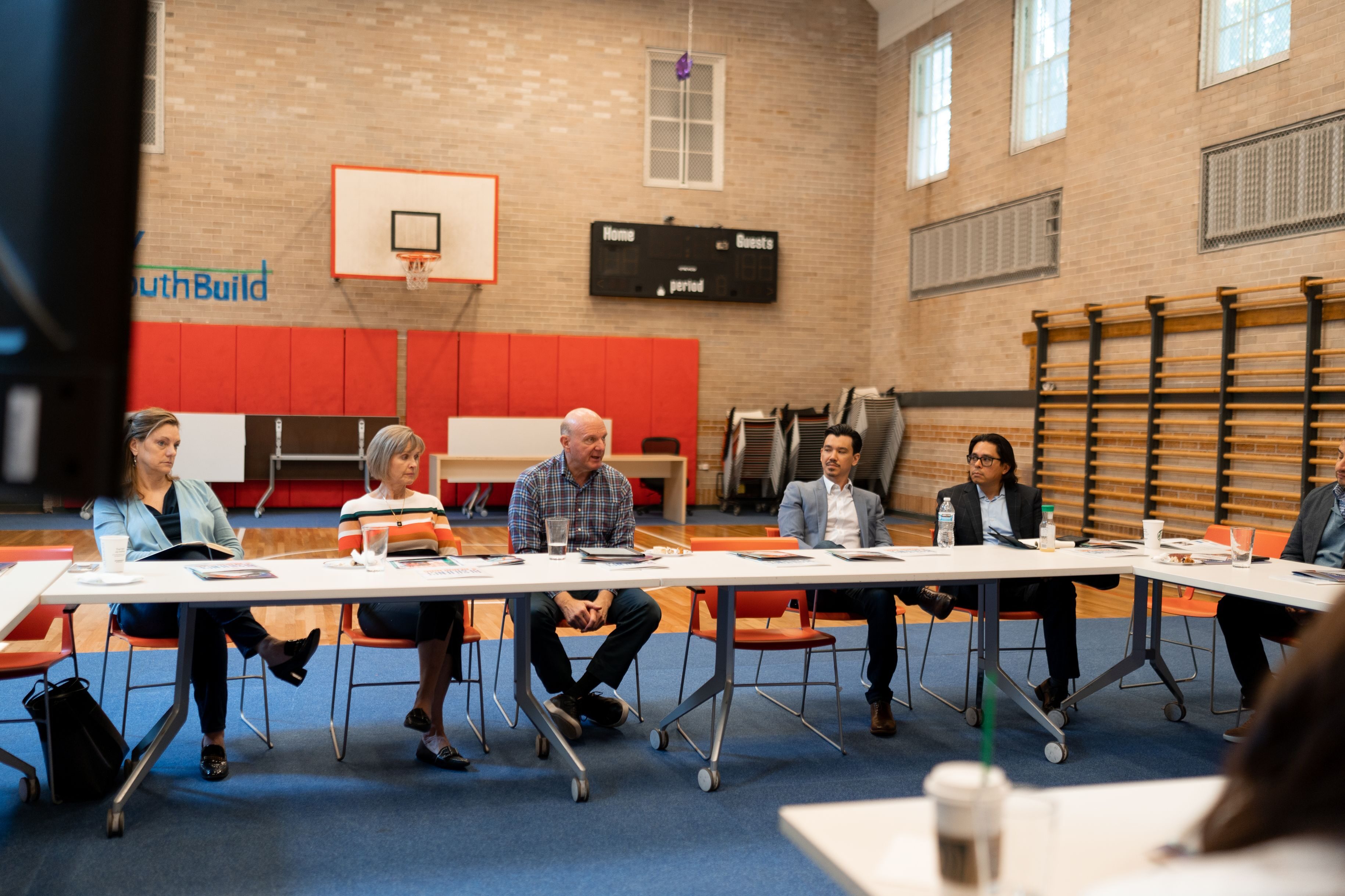 Connie and Steve Ballmer, center, during a Los Angeles site visit to YouthBuild, one of their grantees.