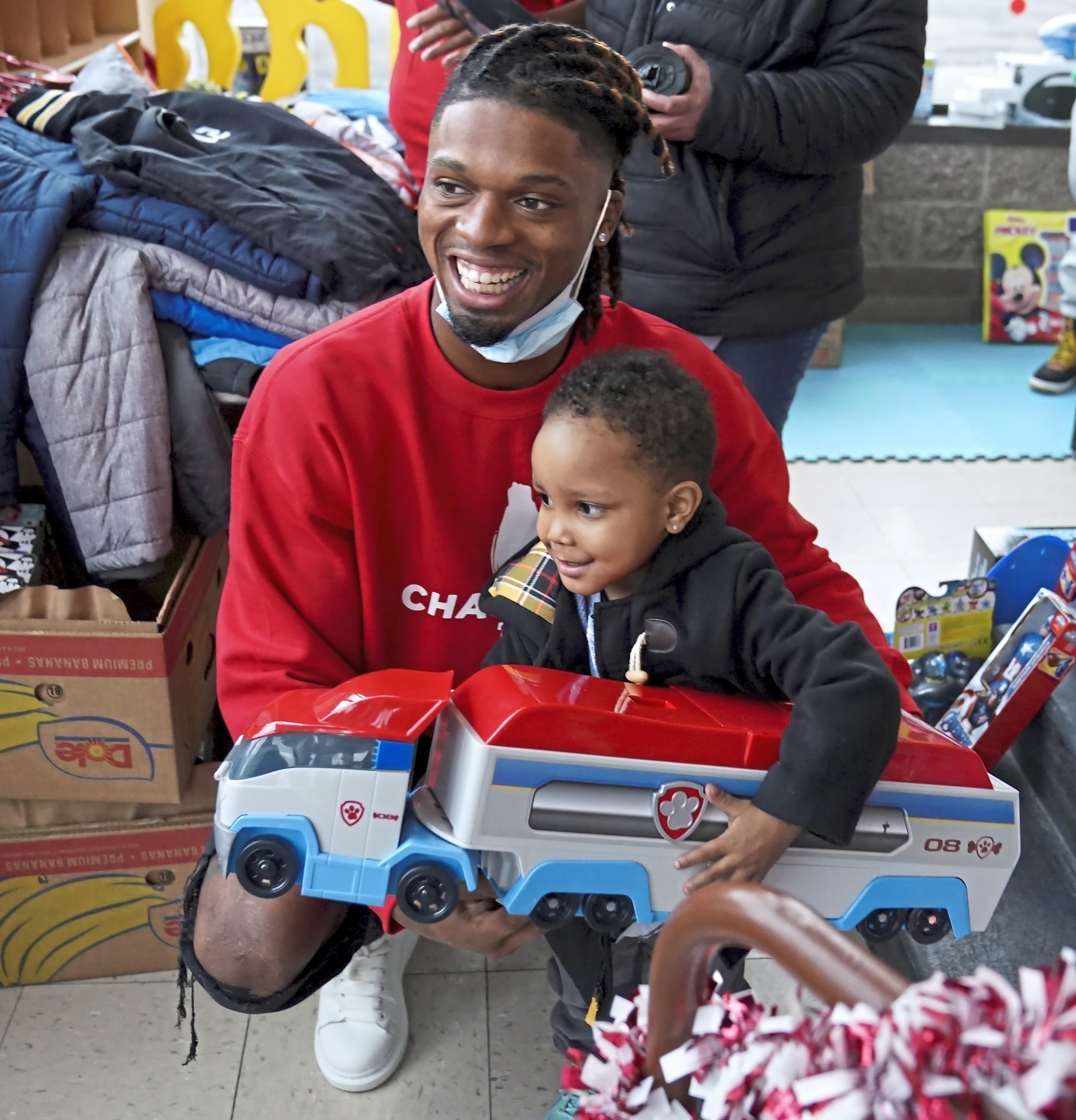 FILE - Pittsburgh NCAA college football defensive back Damar Hamlin poses for a photo with Bryce Williams, 3, of McKees Rocks, Pa., after the youngster picked out a toy during Hamlin’s Chasing M’s Foundation community toy drive at Kelly and Nina’s Daycare Center, Tuesday, Dec. 22, 2020, in McKees Rocks, Pa. Buffalo Bills safety Damar Hamlin plans to support young people through education and sports with the $8.6 million in GoFundMe donations that unexpectedly poured into his toy drive fundraiser after he suffered a cardiac arrest in the middle of a game last week. (Matt Freed/Pittsburgh Post-Gazette via AP, File)