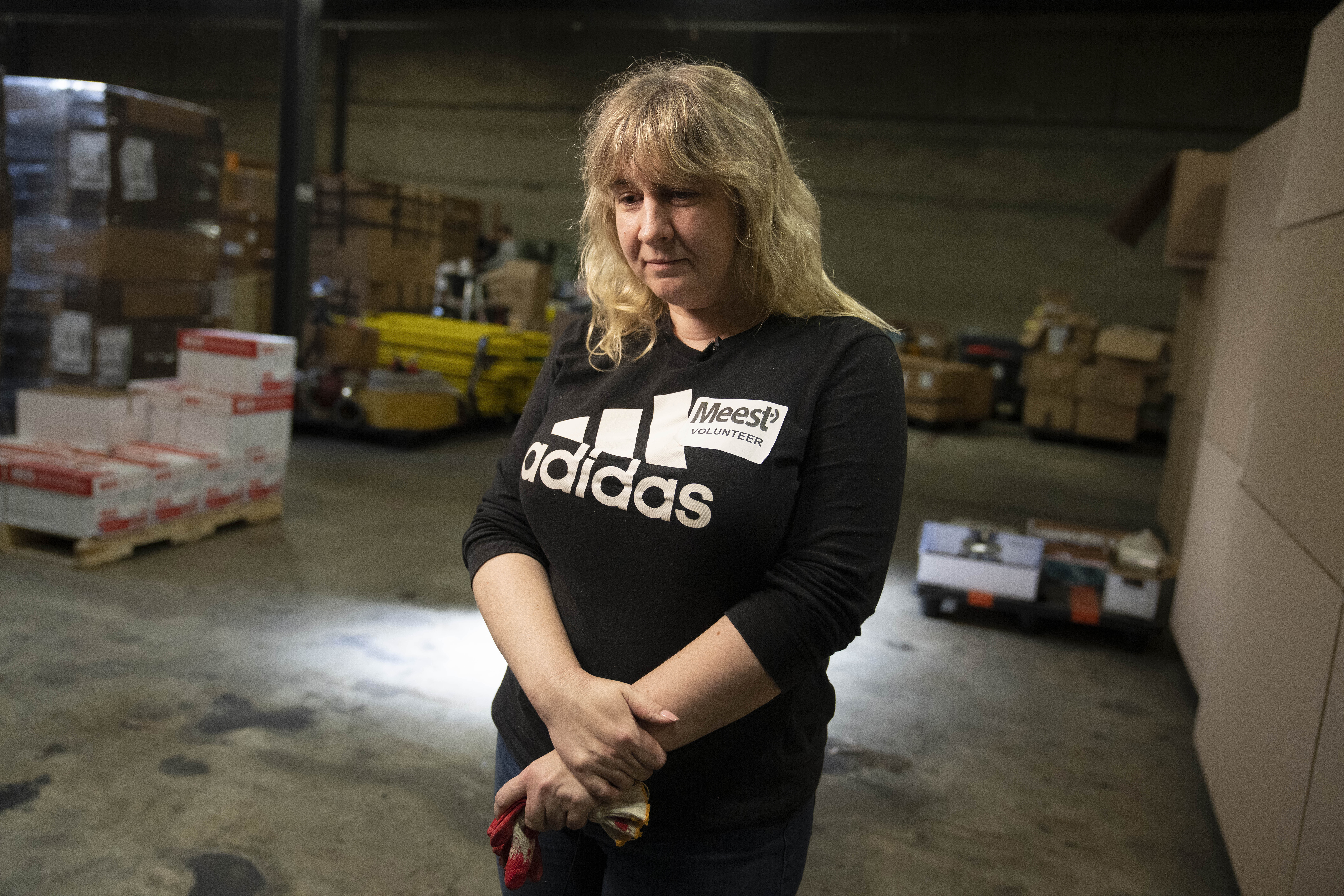 Valeriya Roshkovan pauses during an interview as she volunteers for Razom for Ukraine, a New York-based nonprofit, to help package donated firefighting equipment to ship to her country, Wednesday, Feb. 8, 2023, in Woodbridge Township, N.J.