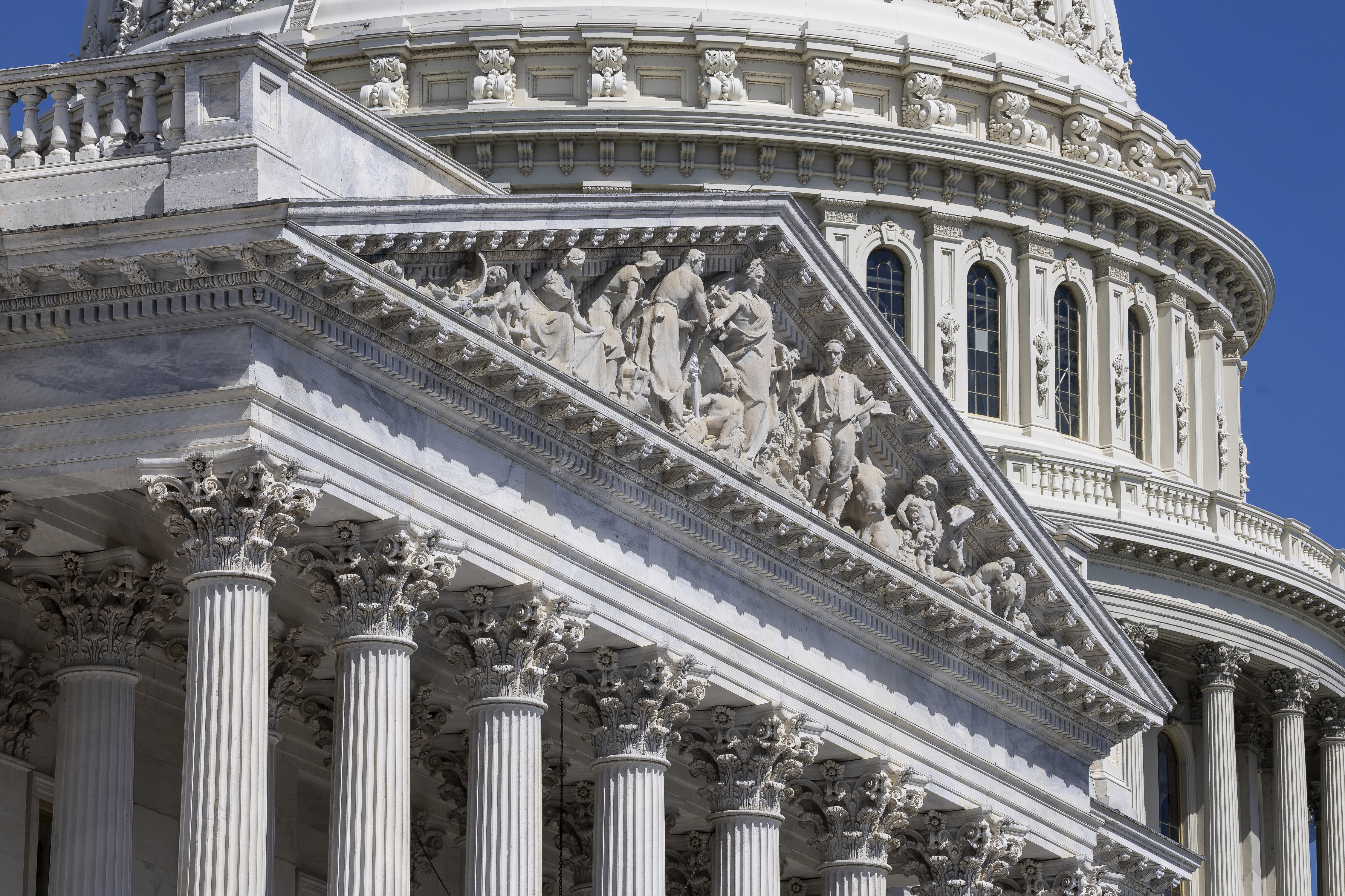 A close-up beauty shot of the U.S. Capitol building against a bright blue sky. 