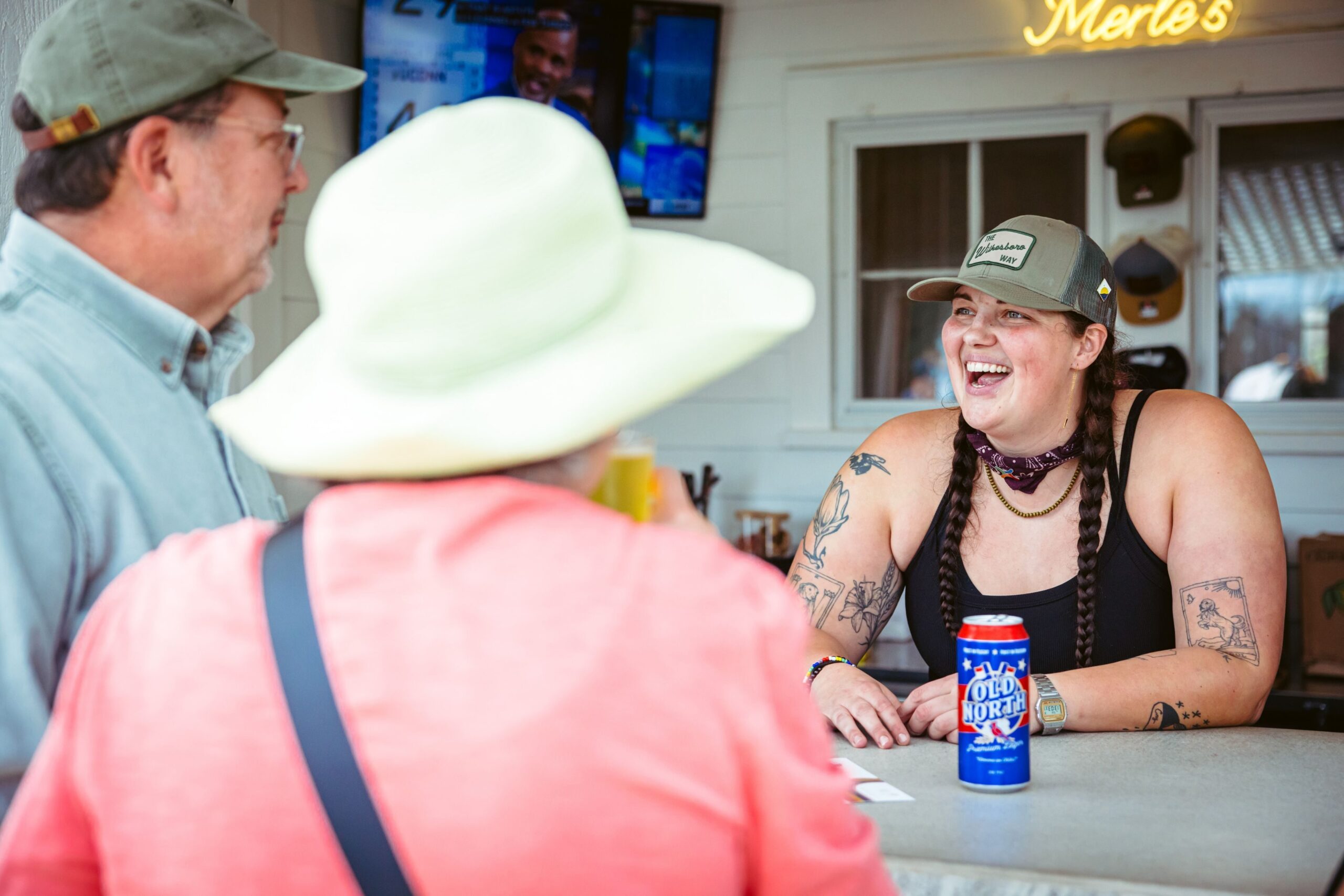 L.B. Privette interacts with customers at the outdoor bar at the cocktail lounge she co-owns called Merle’s in downtown Wilkesboro, NC on March 3, 2024.  