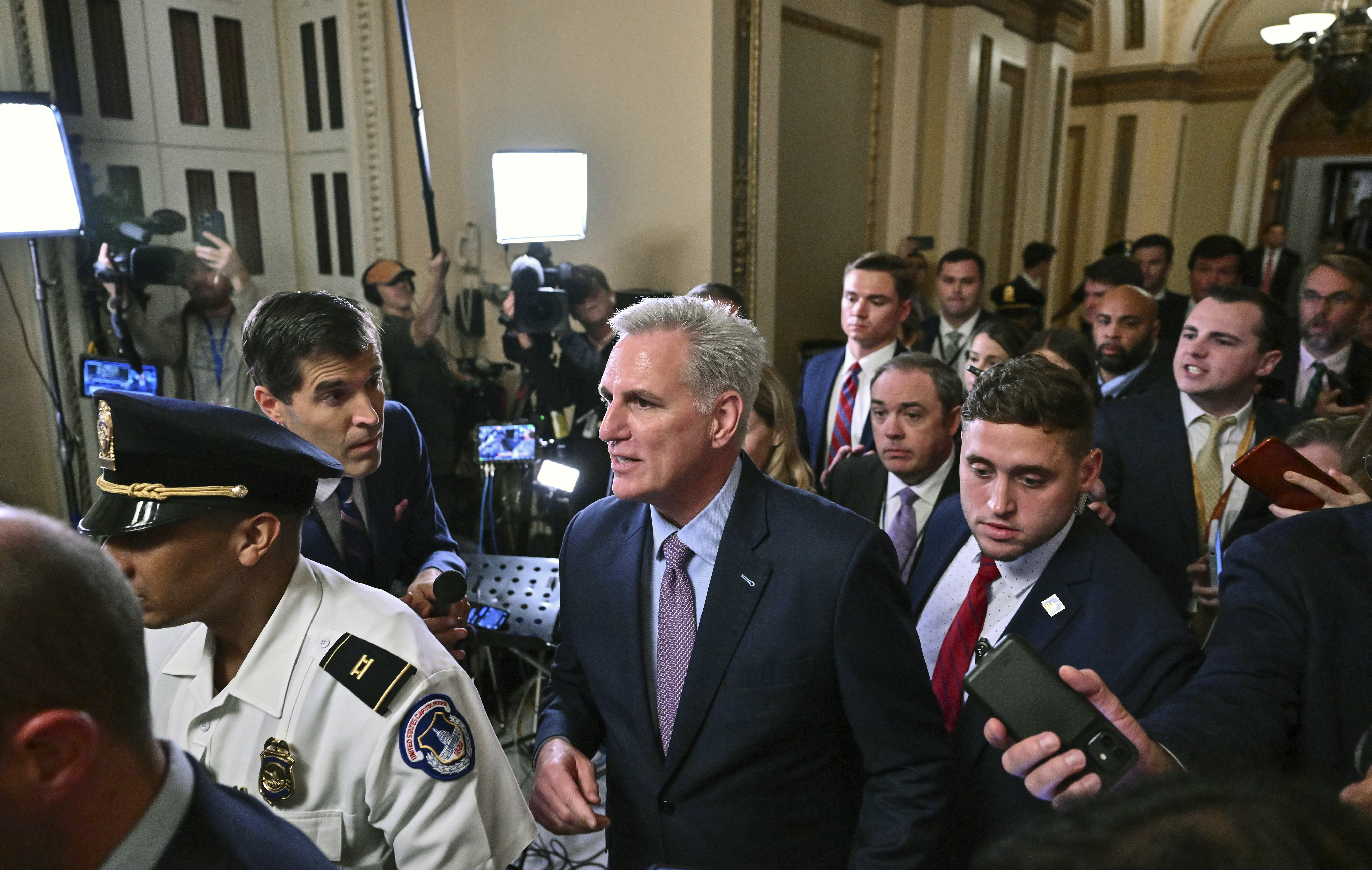Former Speaker of the House Kevin McCarthy (R-Calif.) is escorted from the House floor following a vote to remove him from Speakership duties at the U.S. Capitol on October 3, 2023 in Washington, D.C.
