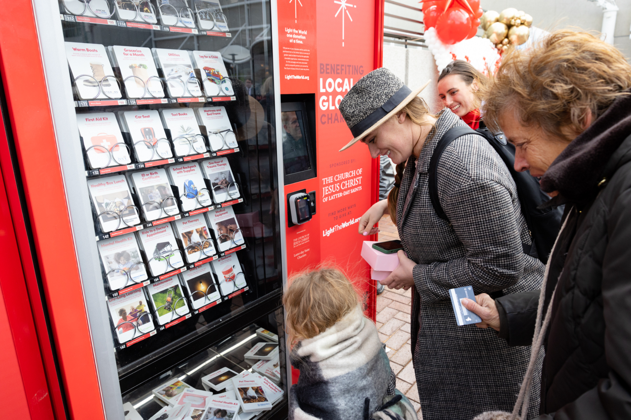 People purchase items for those in need at the opening of the Light the World Giving Machines at Crown Center in downtown Kansas City on Wednesday, November 16, 2022. Courtesy Church of Jesus Christ of Latter-day Saints.