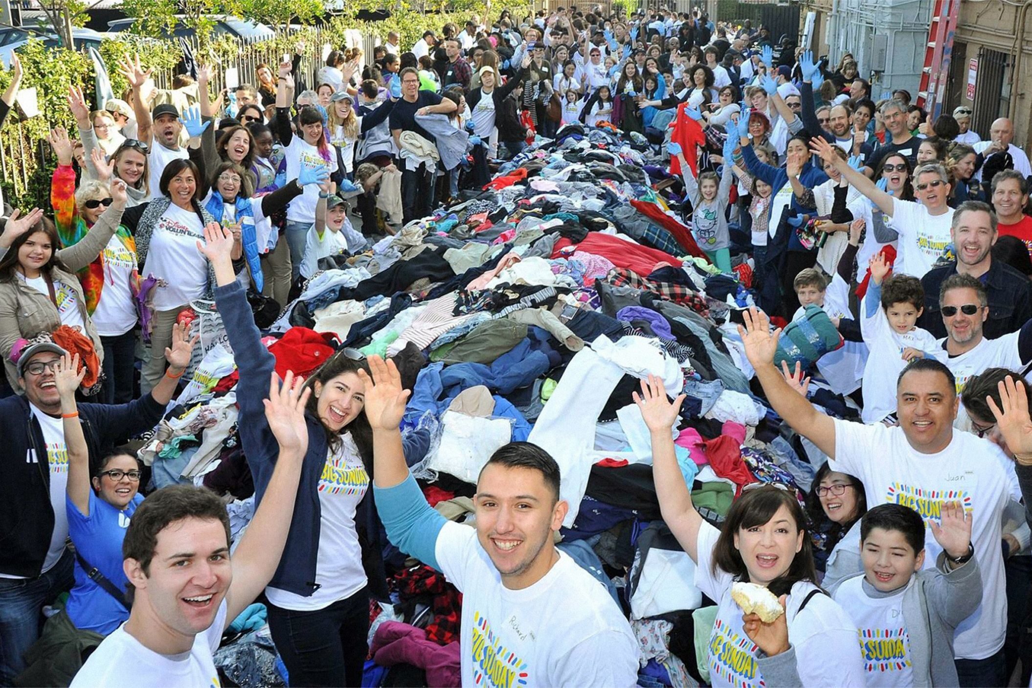 Volunteers gather around a pile of clothes
