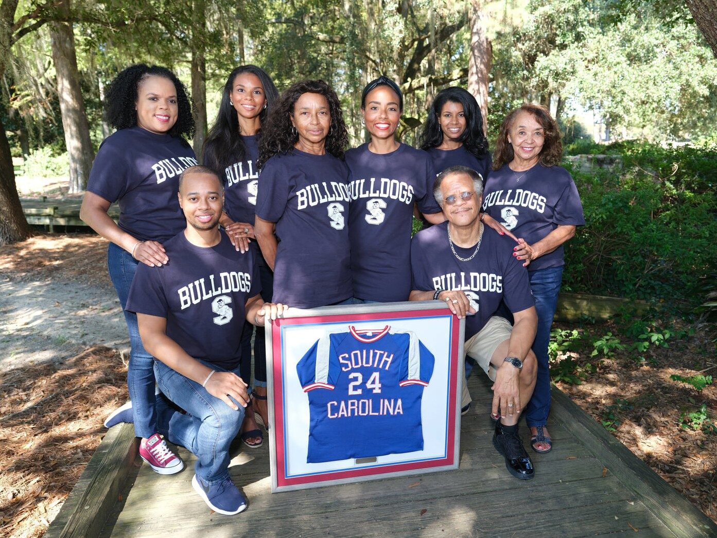 Tycely Williams and her family gathered at South Carolina State University in 2020 for the posthumous induction of her father, Tyrone Williams, Sr., into the university’s Athletics Hall of Fame. L to R: First Row: Tyrone Williams, II (brother)/kneeling, Jerona A. Williams (mother), self, Herman Willams (uncle) Second Row: Traci Williams (cousin), Tyrenda Williams Reed (sister), Tyra Williams-Pickens (sister) & Mary Matthews (step-mother).