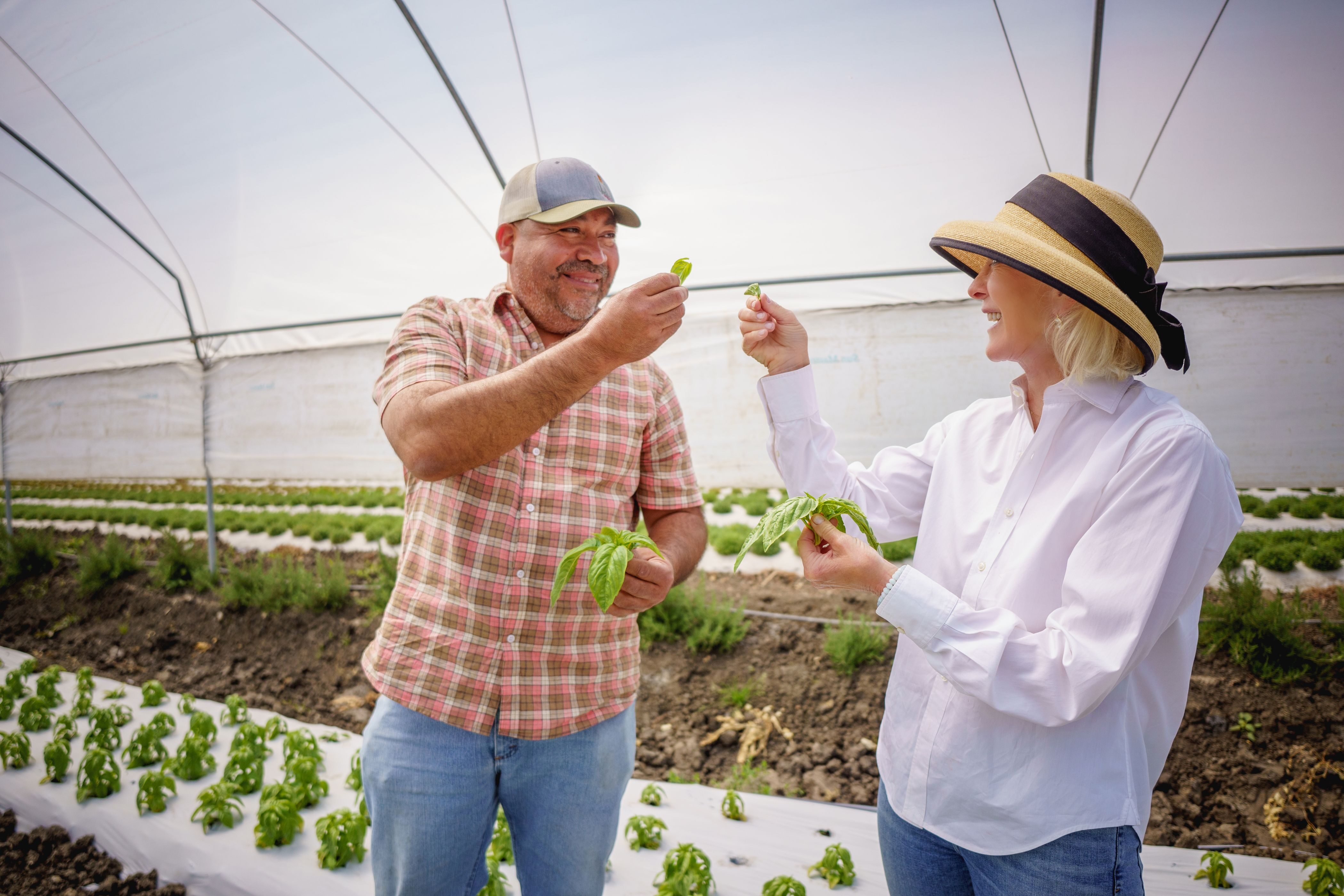 The Schmidts support sustainable agriculture as a way to curb climate change. Here, Wendy talks with grantee Javier Zamora, owner of JSM Organics, who runs a 100- acre farm in Watsonville, Calif.