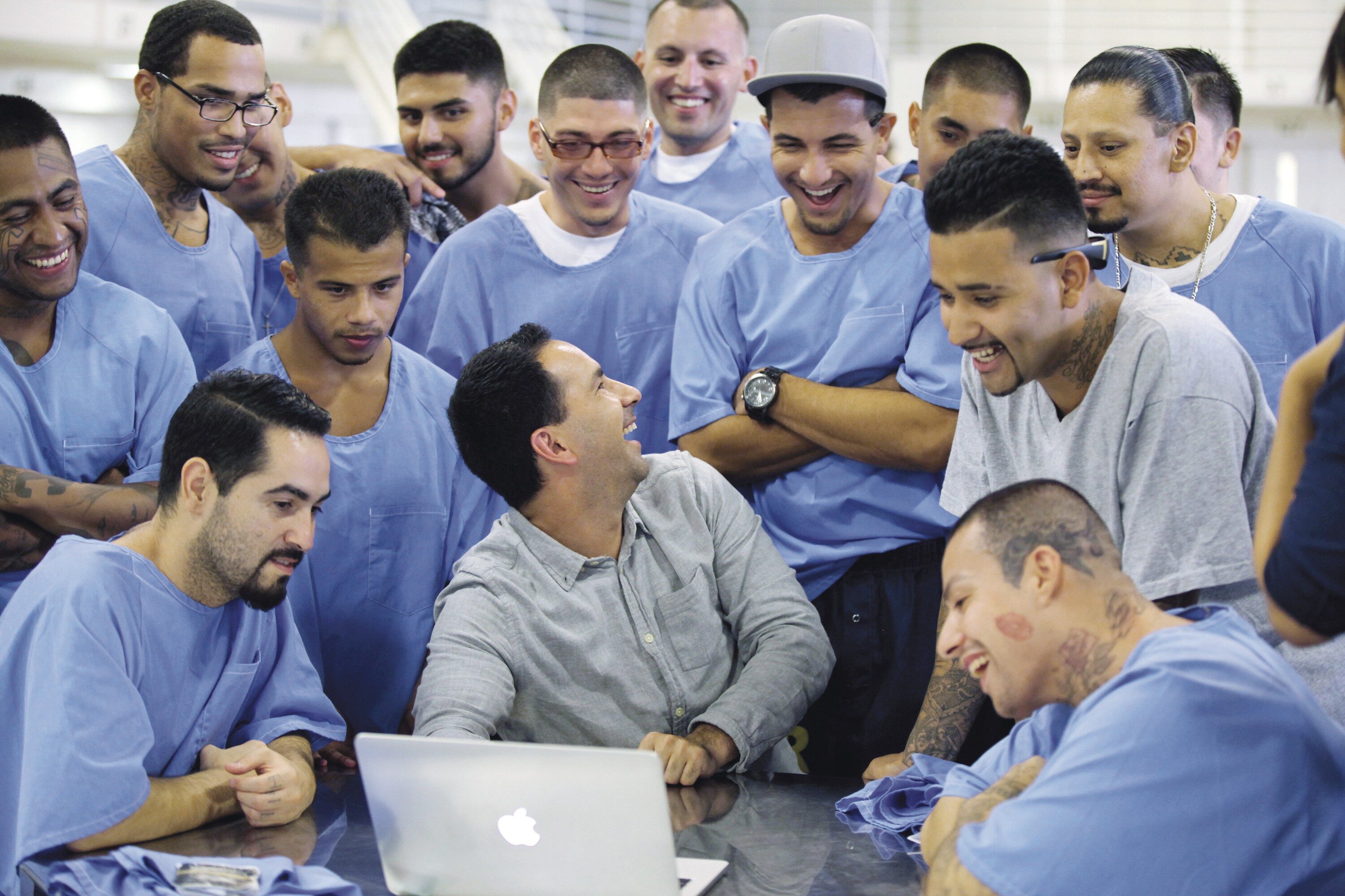 A WINDOW INTO THEIR FUTURE: Scott Budnick shows men at Ironwood State Prison in California photos of former fellow inmates who are now getting their lives back on track with the help of his Anti-Recidivism Coalition.