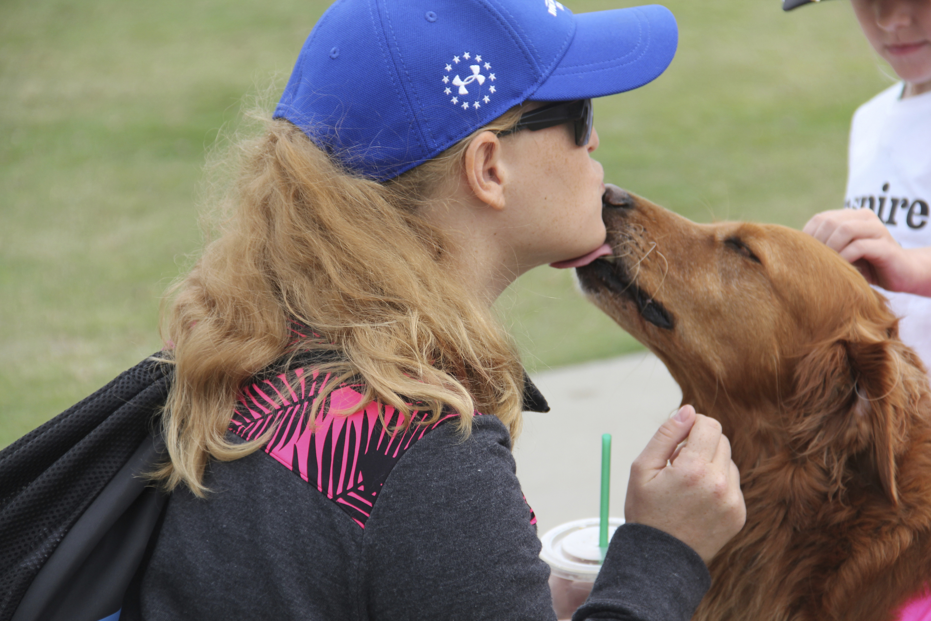 Military service members like Esther (shown here with Ricochet) volunteer to be on the water team to help K9 assisted surfers. 