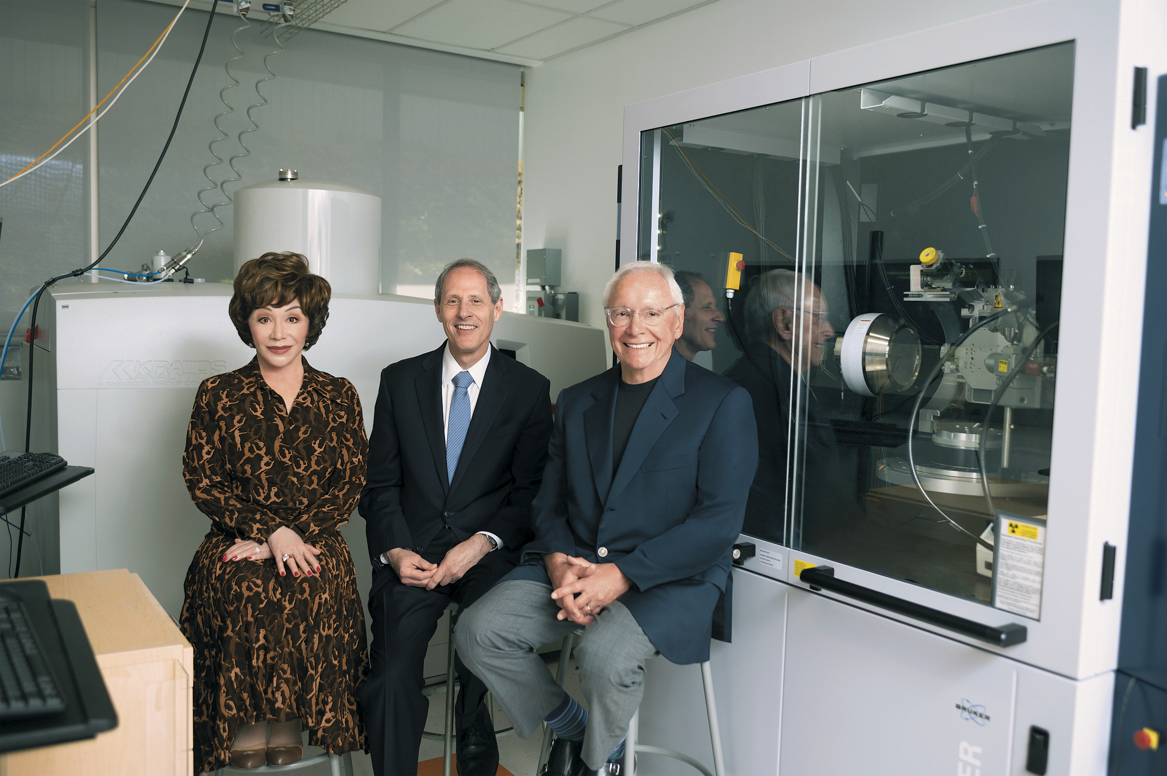 Lynda and Stewart Resnick flank Thomas Rosenbaum, president of the California Institute of 
Technology, at the university’s Joint Center for Artificial 
Photosynthesis. In 2019, the 
couple gave Caltech $750 million for climate-change research.