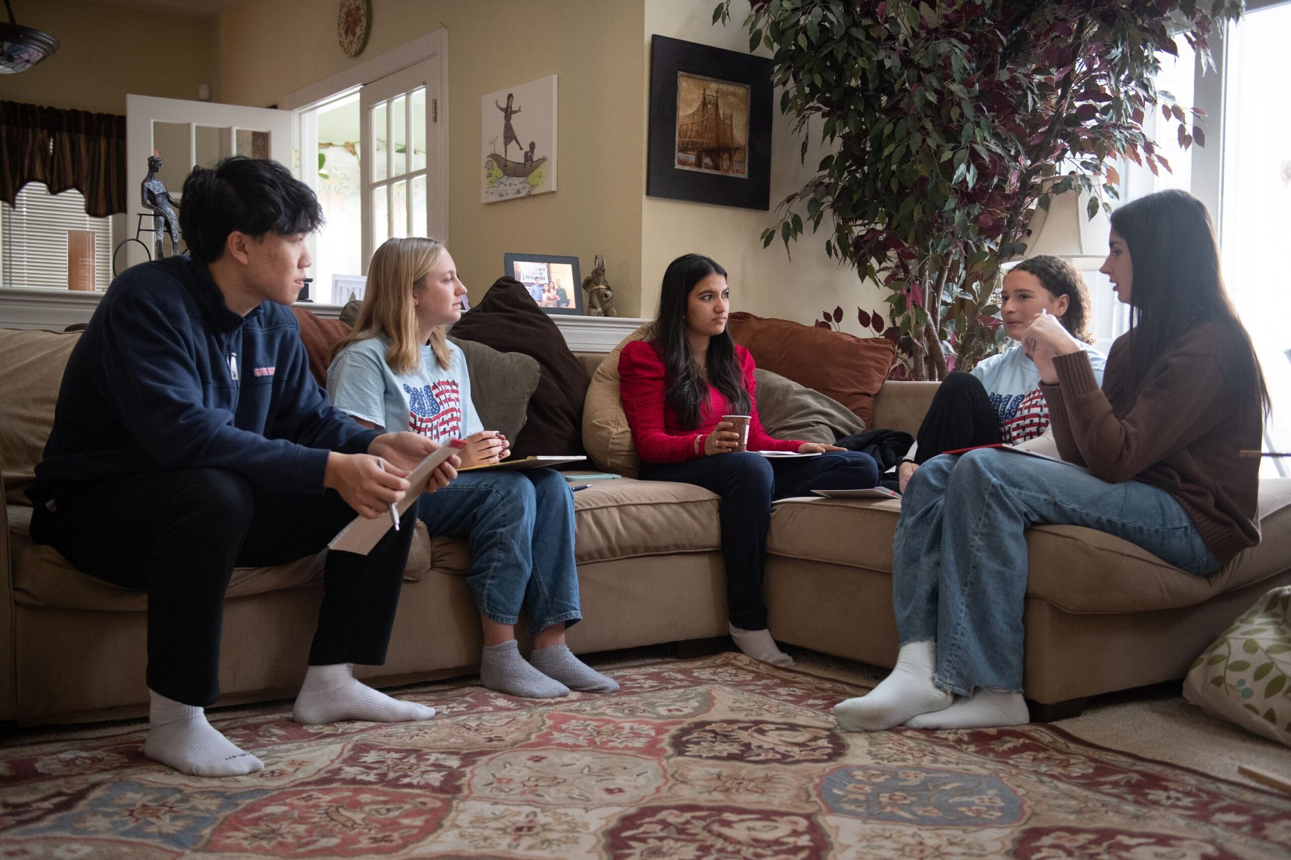 Jahnavi Rao (center) meets with high school members of the New Voters organization at her home in Berwyn, Pennsylvania.