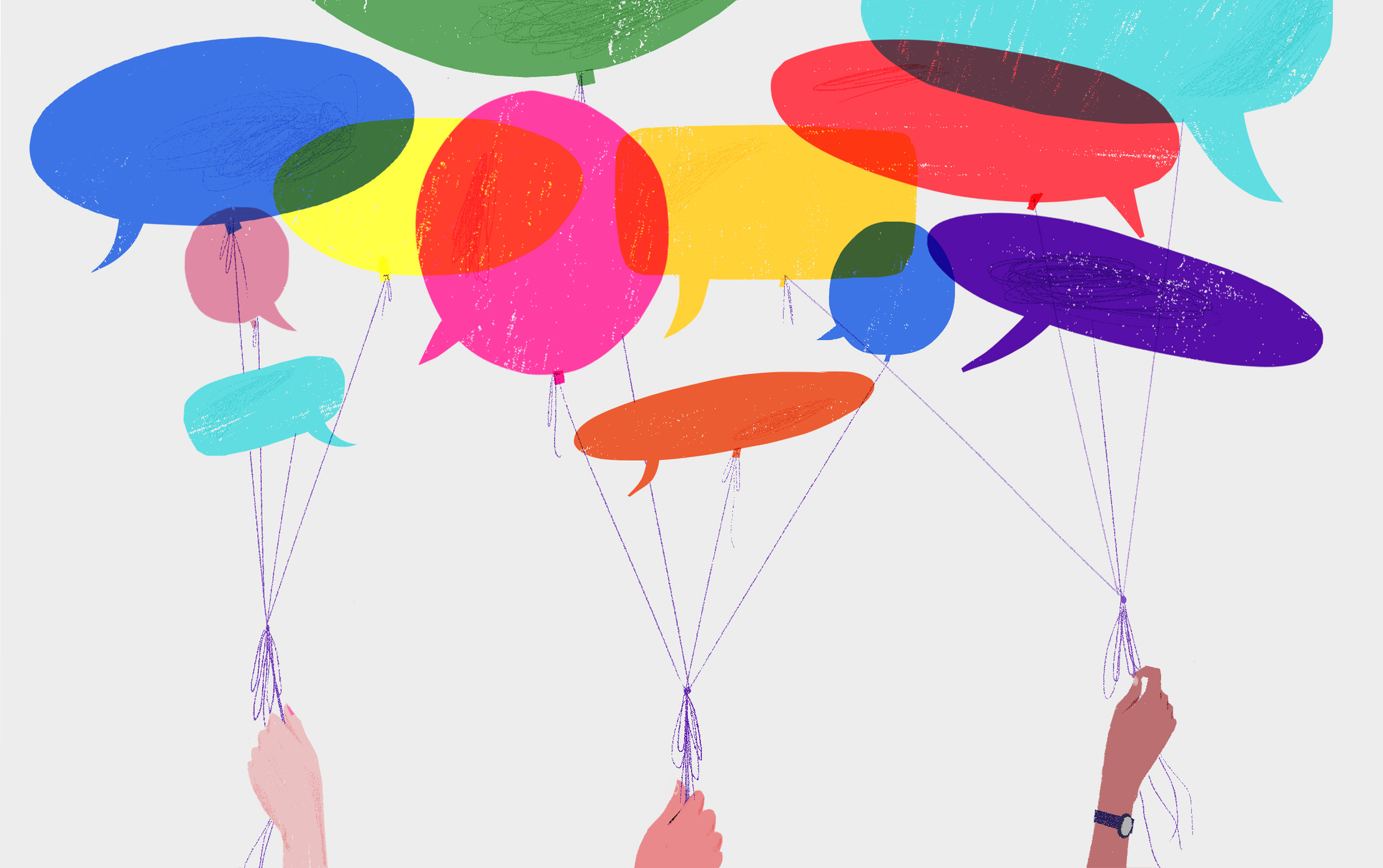 Several hands hold the strings on a group of balloons made of difference colored speech bubbles.