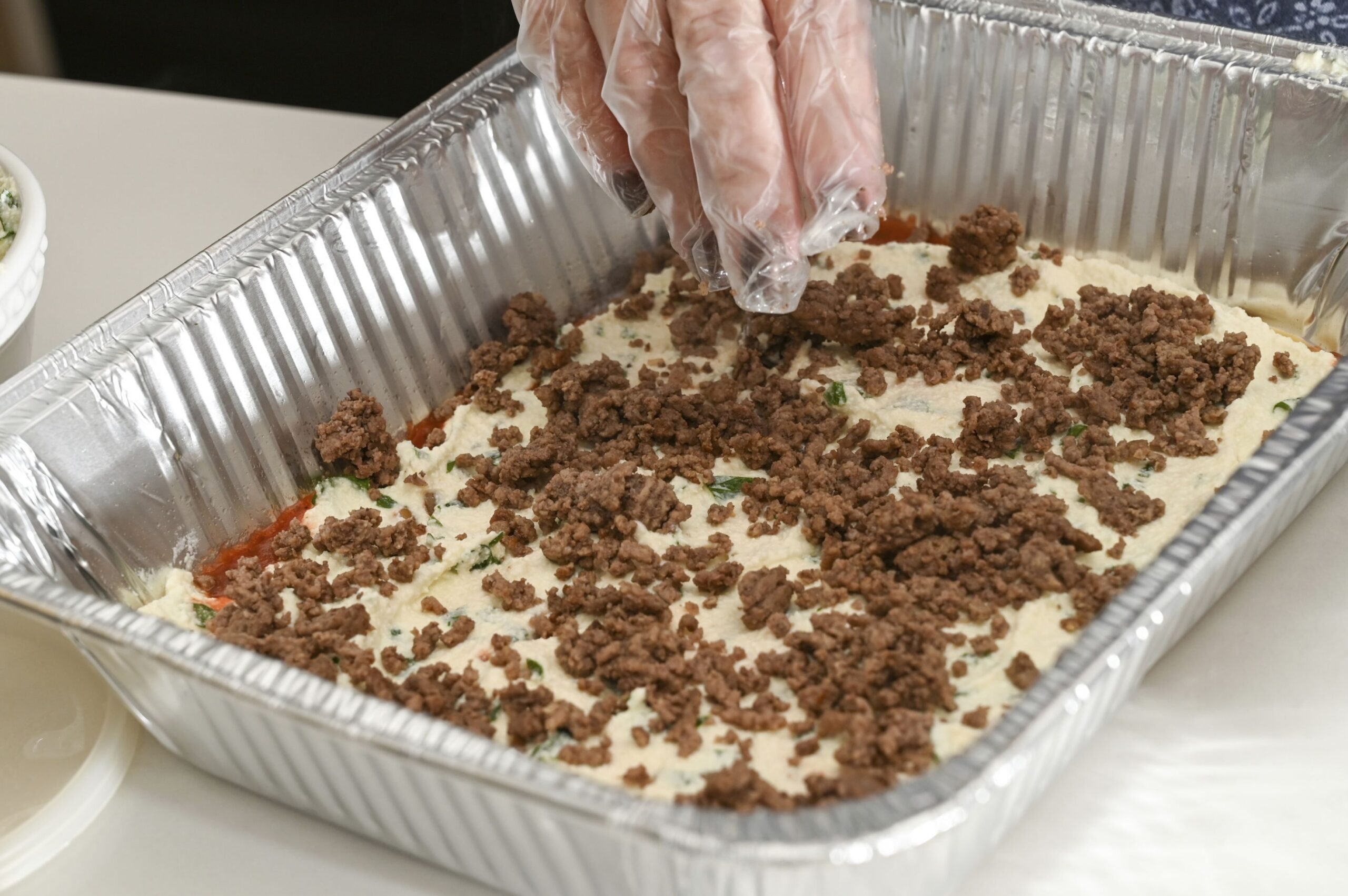 Shari DiBrito, the New Jersey regional director for the nonprofit Lasagna Love, makes a lasagna on May 1, 2021, at her niece’s house in Wayne, N.J.