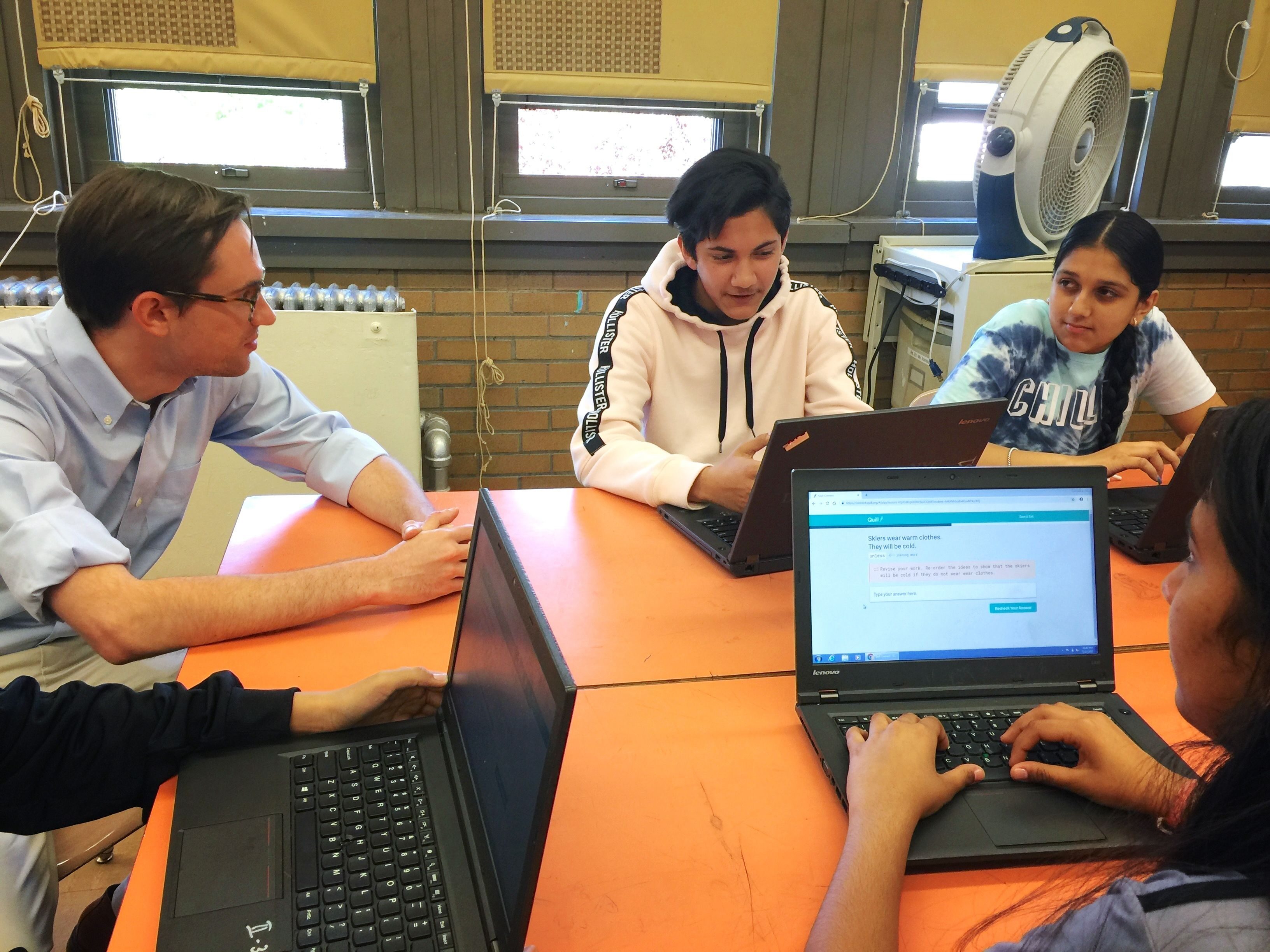Quill.org founder Peter Gault with NYC high school students using Quill.org’s technology.