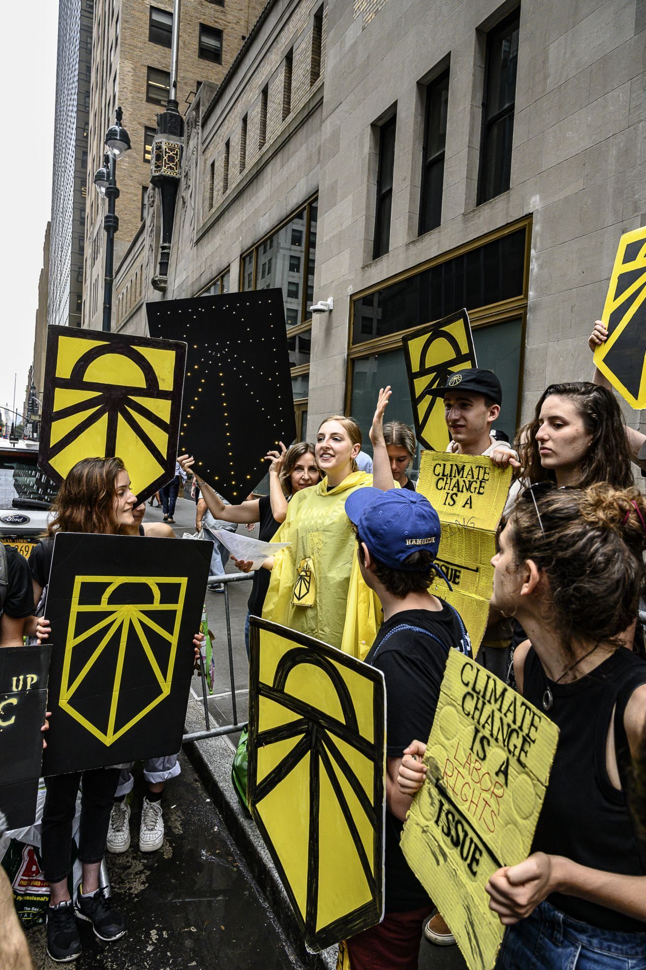 Jessie Bluedorn, center in yellow poncho, at a climate protest. Photo by Ken Schles, Courtesy of Jessie Bluedorn
