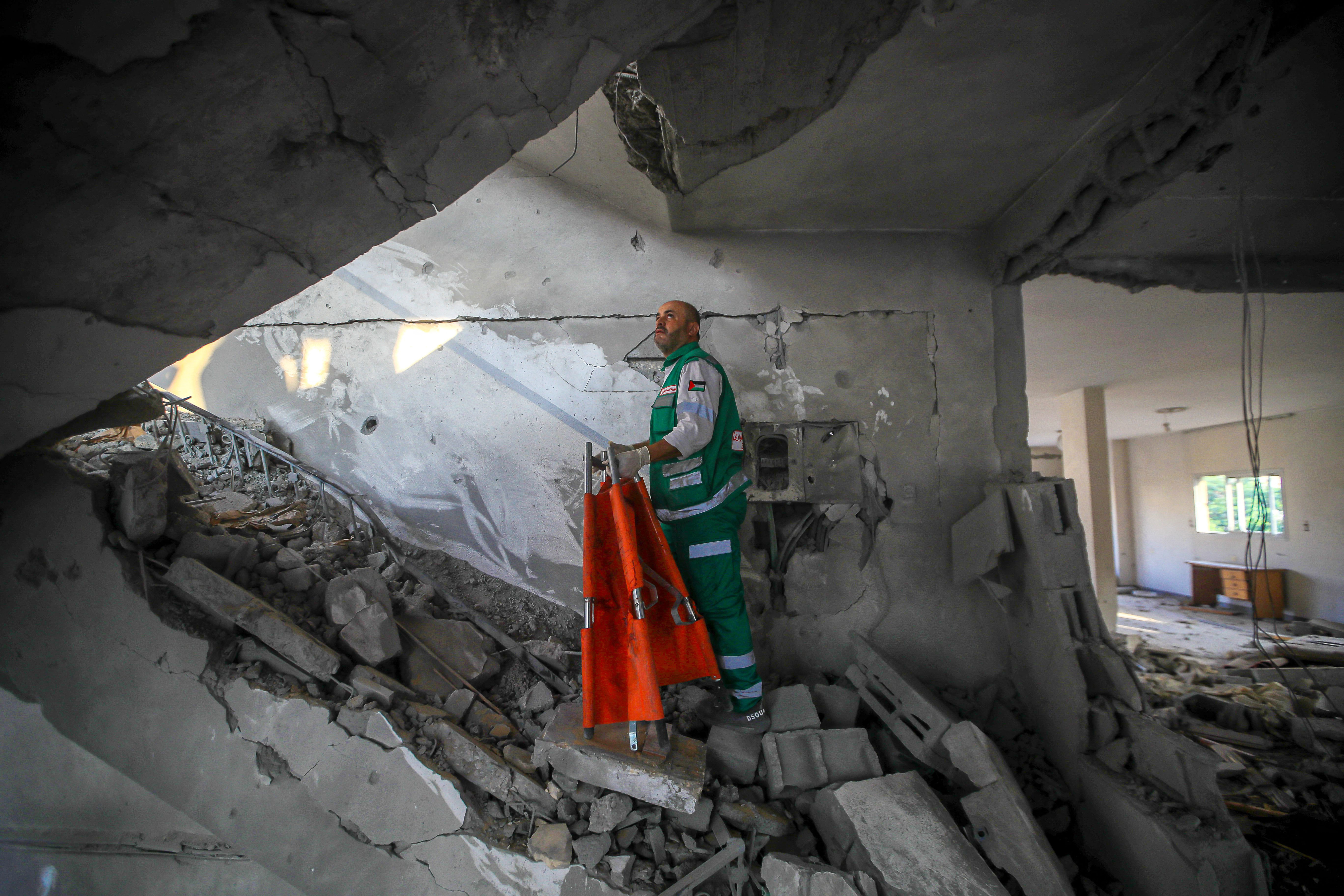 10/08/2023 Gaza, Palestine. A rescue team member searches in buildings damaged by Israeli missile strikes.
