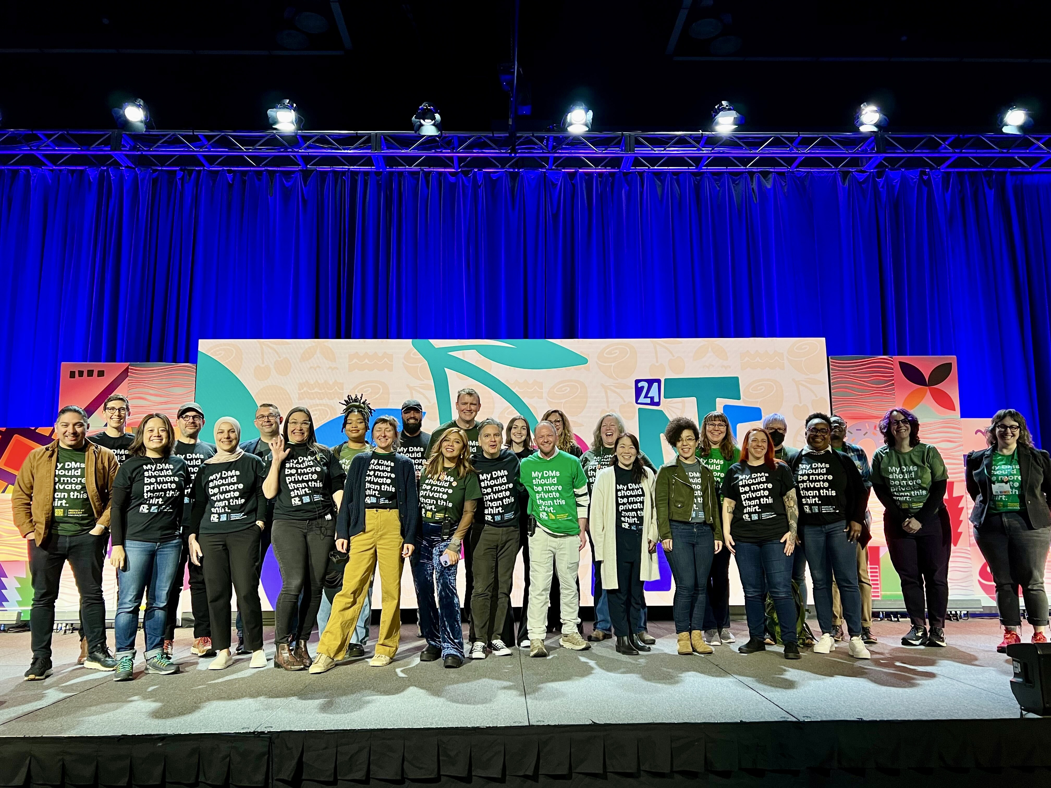 Attendees and NTEN staff at the NTC, wearing shirts for a ‘Make DMs Safe’.
