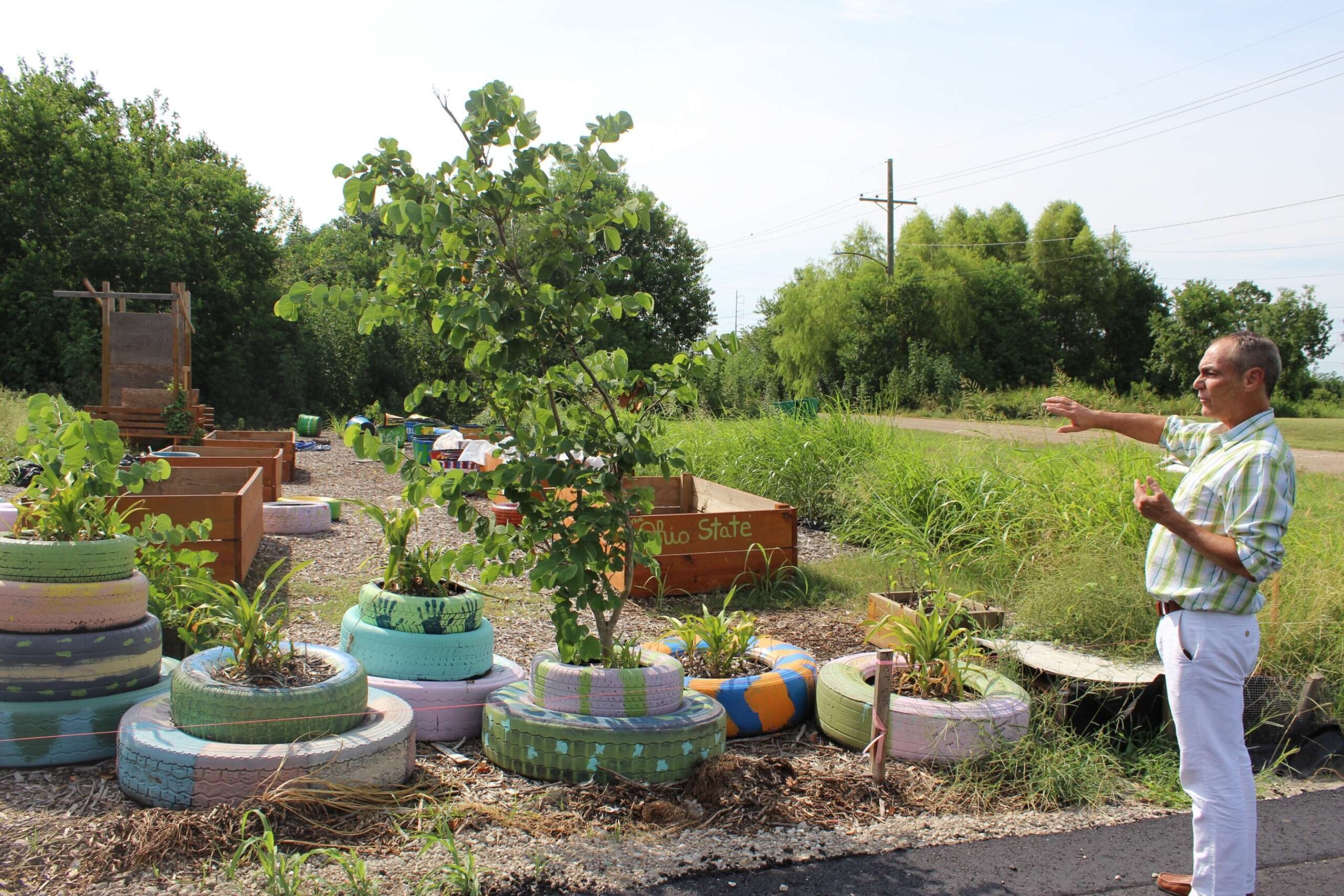 Christopher Cameron, head of HandsOn New Orleans, explains the layout of a community garden the volunteer-focused group started in the Lower Ninth Ward. Nonprofit leaders launched an appreciation campaign to thank donors, nonprofits, and volunteers for their help after Hurricane Katrina. 