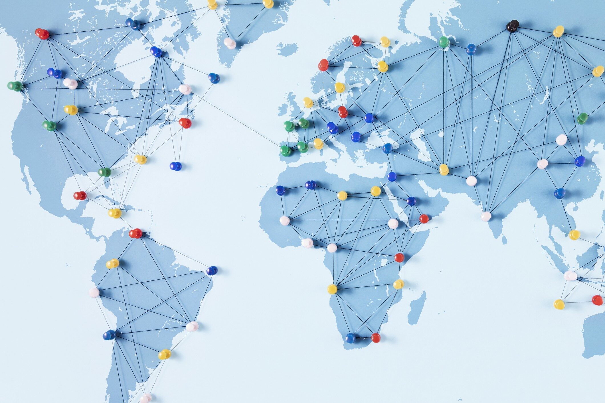 Connection concept with push pins on a world map