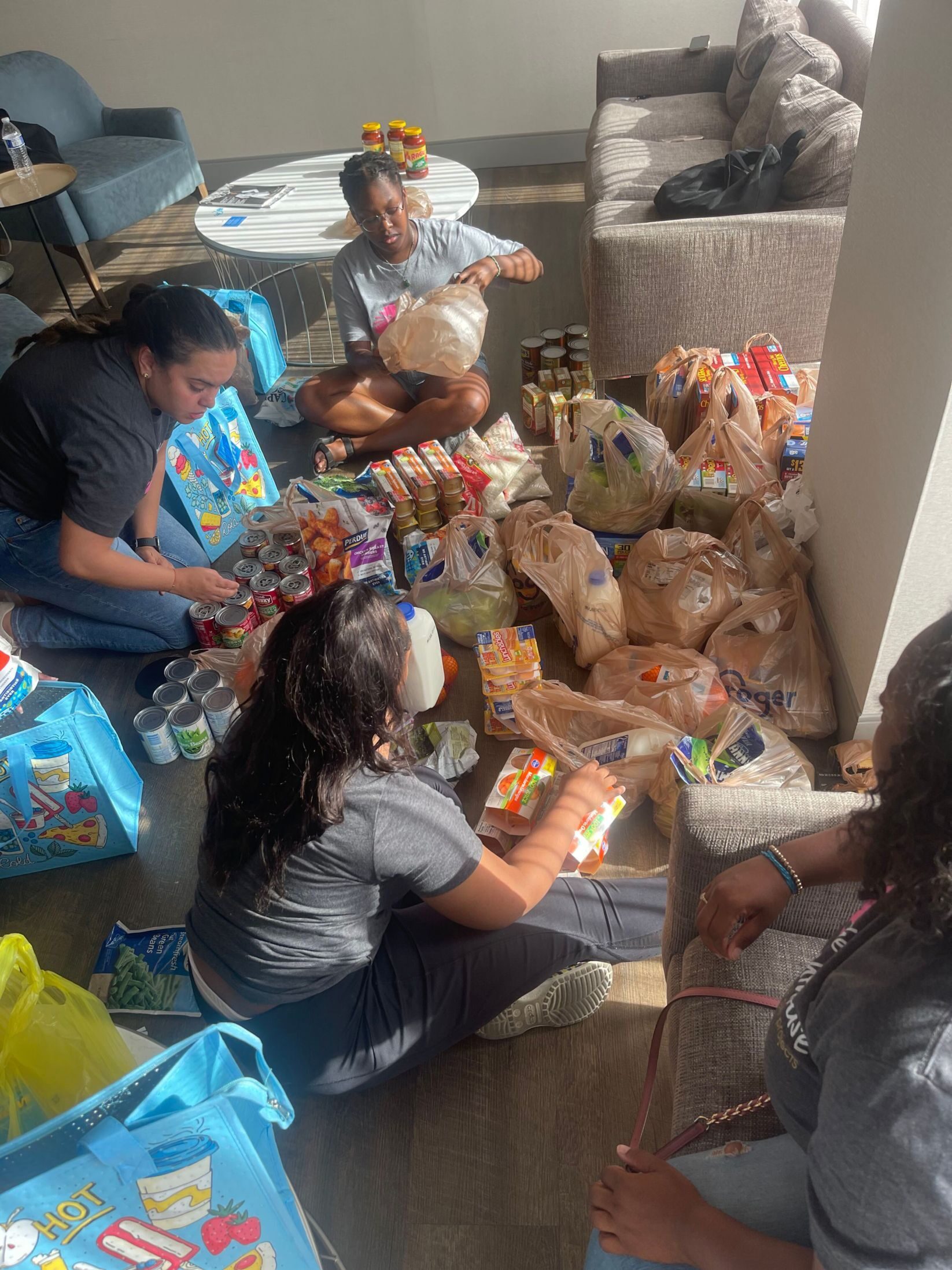 Black Girl Research Institute researchers fill grocery bags for families in need that they encountered in the field. (Courtesy of The Lighthouse Black Girl Projects)