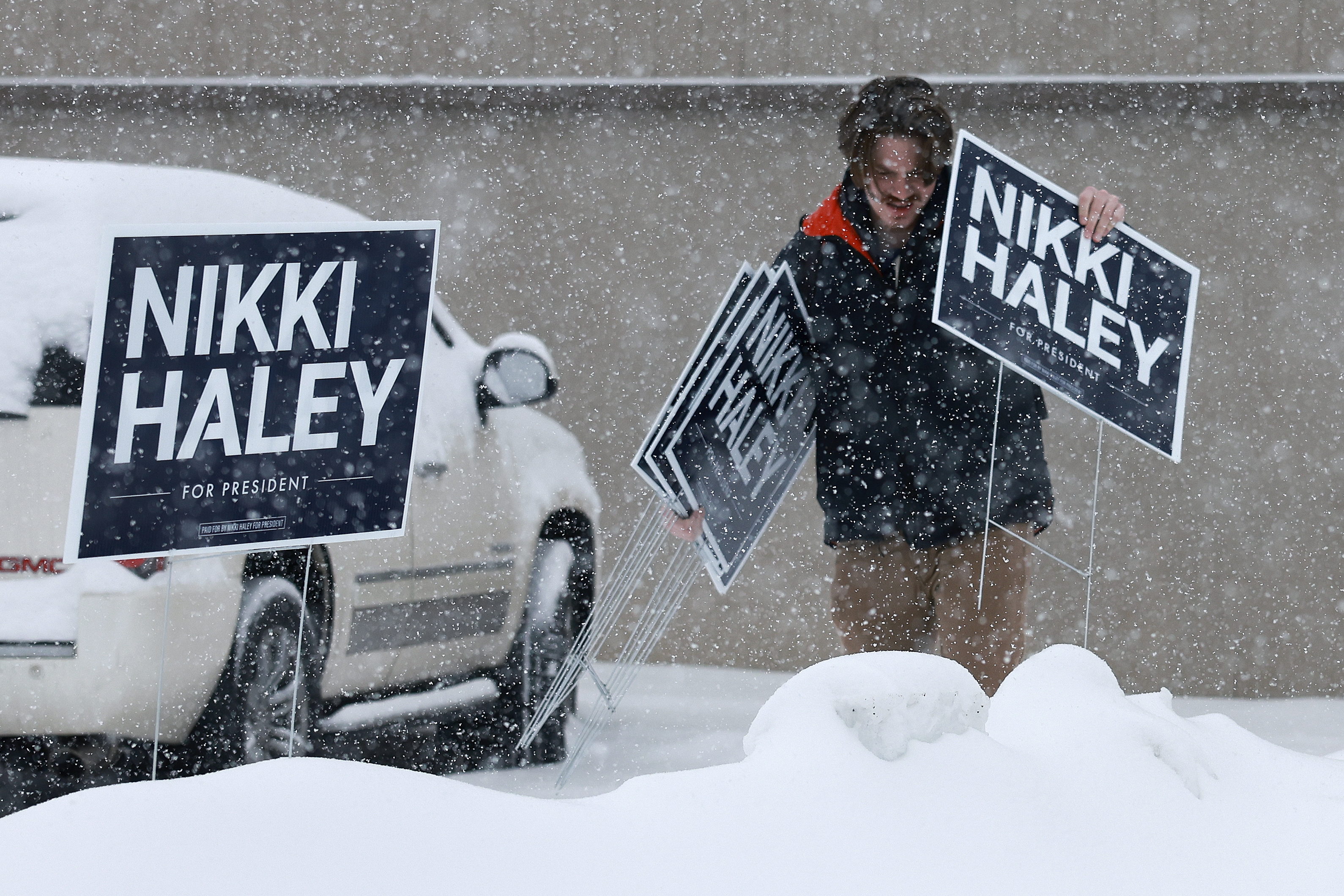 A volunteer for the campaign of Republican presidential candidate former U.N. Ambassador Nikki Haley collects campaign signs outside the Horizon Family Restaurant after the campaign event was cancelled due to inclement weather on January 8, 2024 in Sioux City, Iowa.