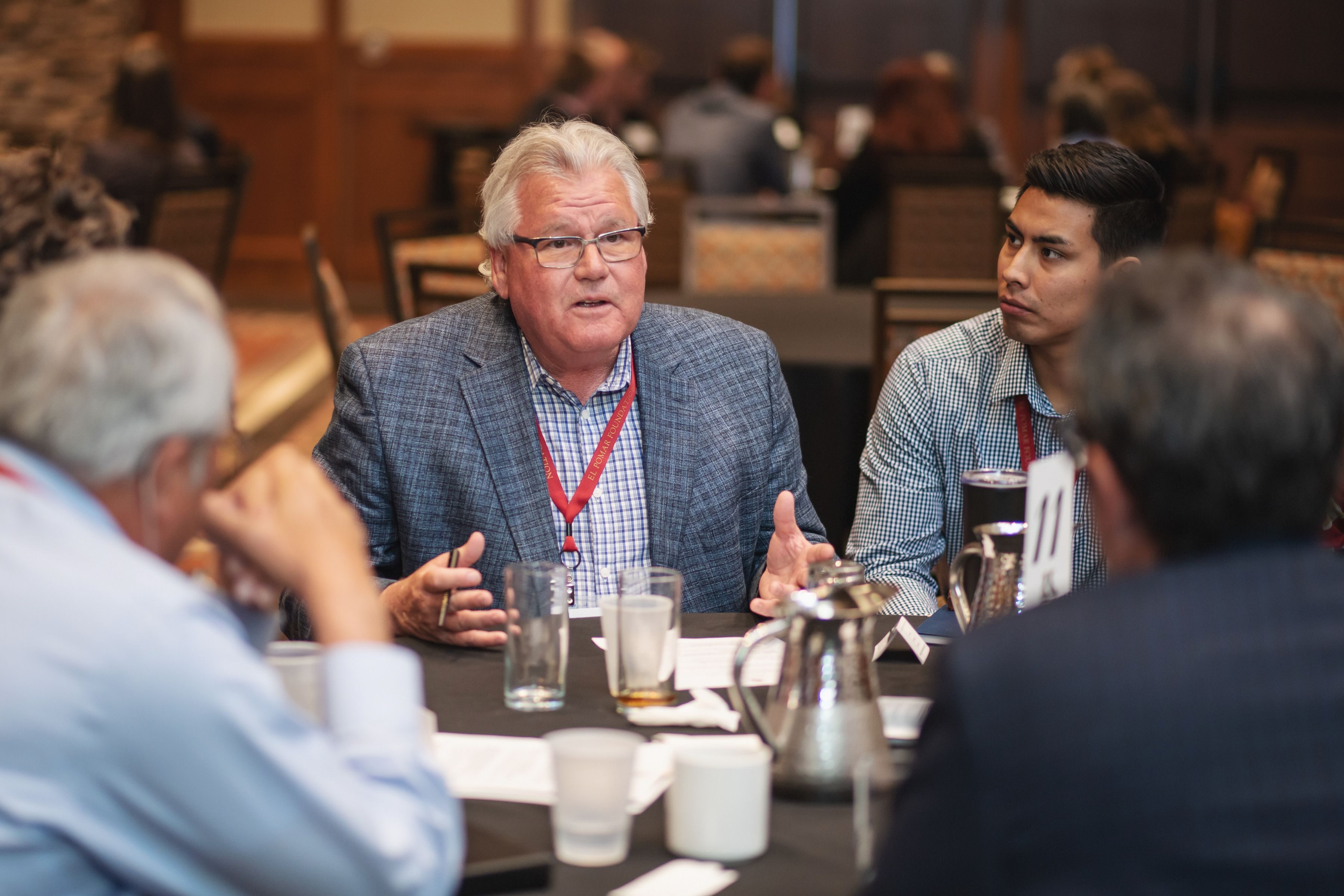 Gregg Rippy, center, a member of the Northwest Regional Council from 2006 to 2024, and Ulises Flores, right, from the El Pomar Fellowship class of 2019, talk with El Pomar regional council members and staff during the General Session of El Pomar’s 2019 Statewide Meeting.