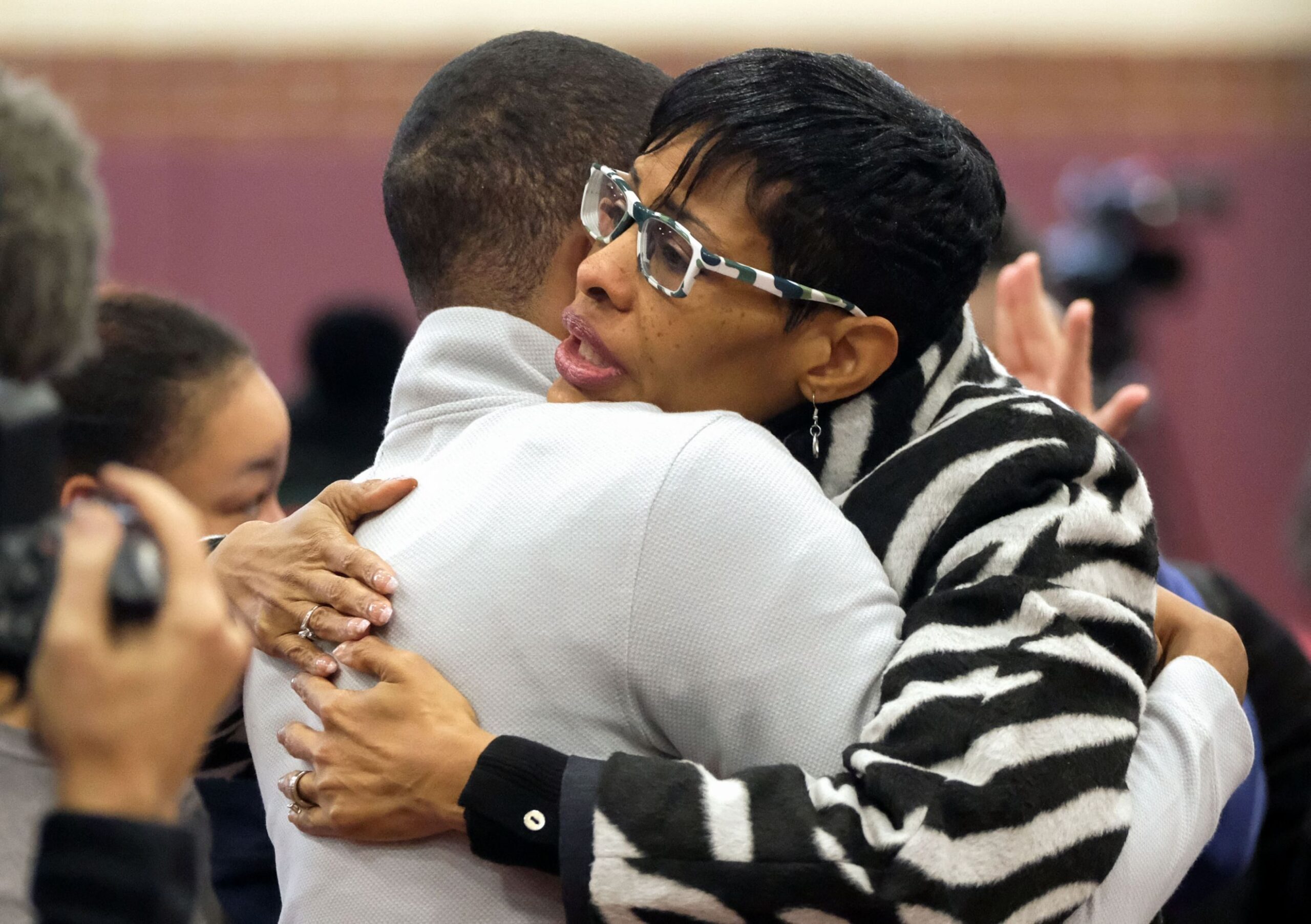 Chris Rowland, 17, left, hugs his mom, Abena Rowland (cq), after finding out that his college will be paid for by Hope Toledo during an assembly in the field house at Scott High School in Toledo on Wednesday, Jan. 29, 2020. It would be revealed later in the announcement that the offer would also extend to one parent or legal guardian.