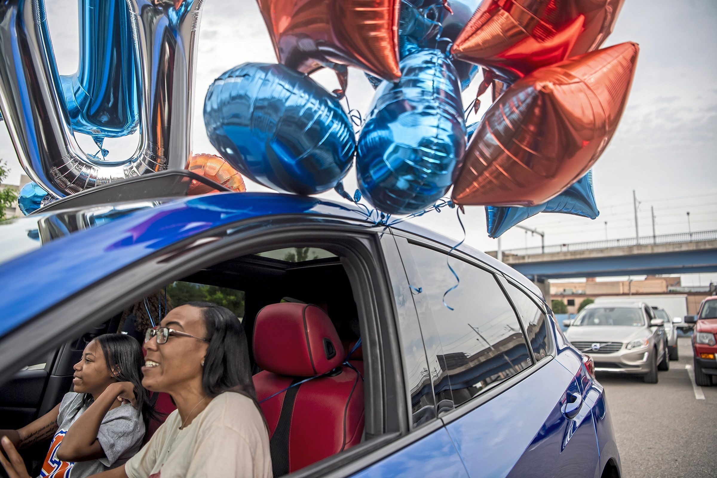 Atasia Little, 17, a Taylor Allderdice High School graduate who will be attending Lincoln University, and her mother Tanisha Austin talk in their car before the “Promise Senior Signing Day” drive-in event to honor graduating high school seniors by Pittsburgh Promise, Saturday, May 22, 2021, in Pittsburgh, Pa. The Pittsburgh Promise provides with scholarships up to $5,000 a year. Because of the COVID-19 pandemic minimum GPA and attendance requirements for students in the Pittsburgh Public Schools class of 2021 were removed.